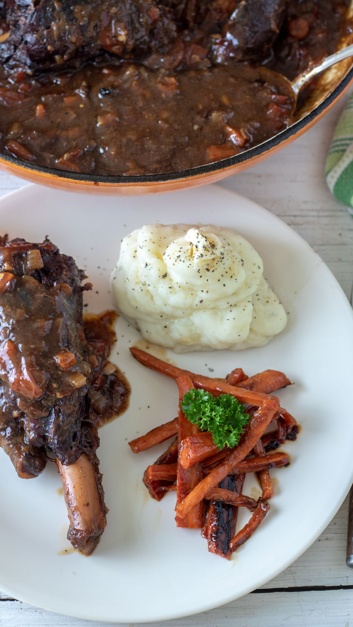 venison leg with potatoes and brown sugar glazed carrots.