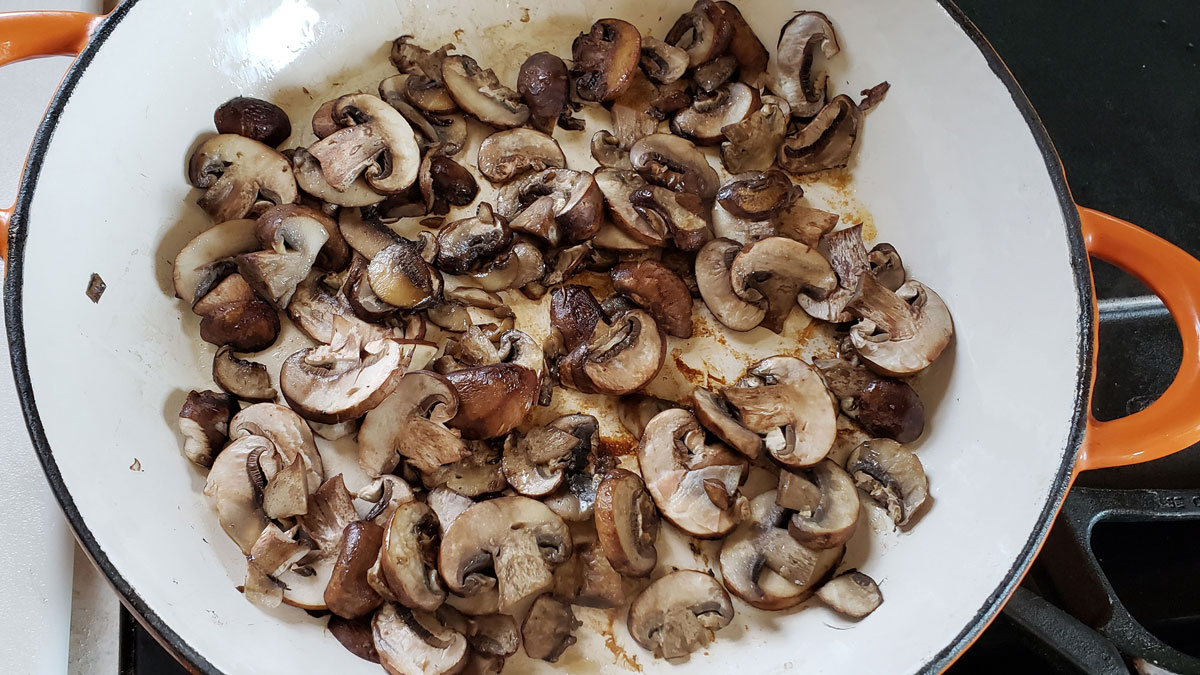 Sliced mushrooms in a skillet.