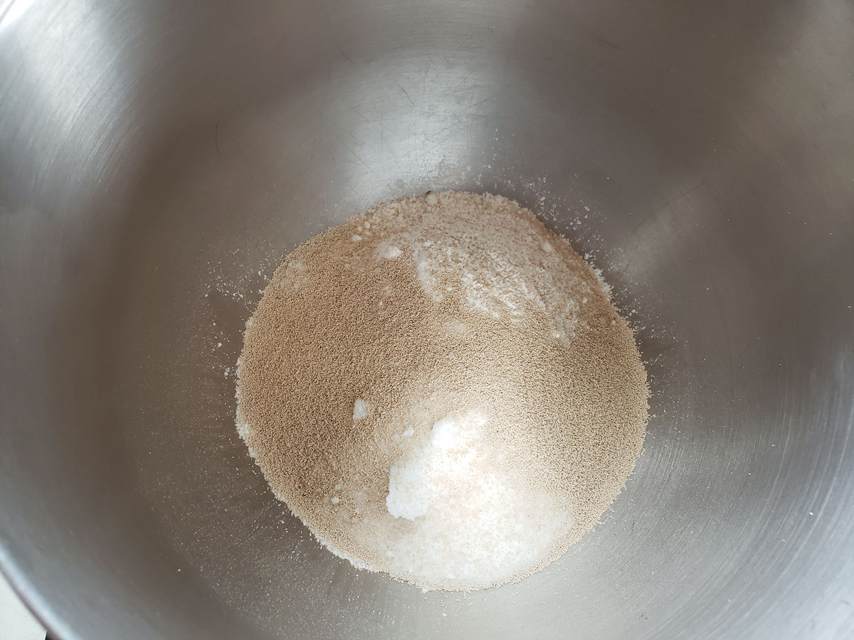 Flour and yeast in a mixing bowl. 