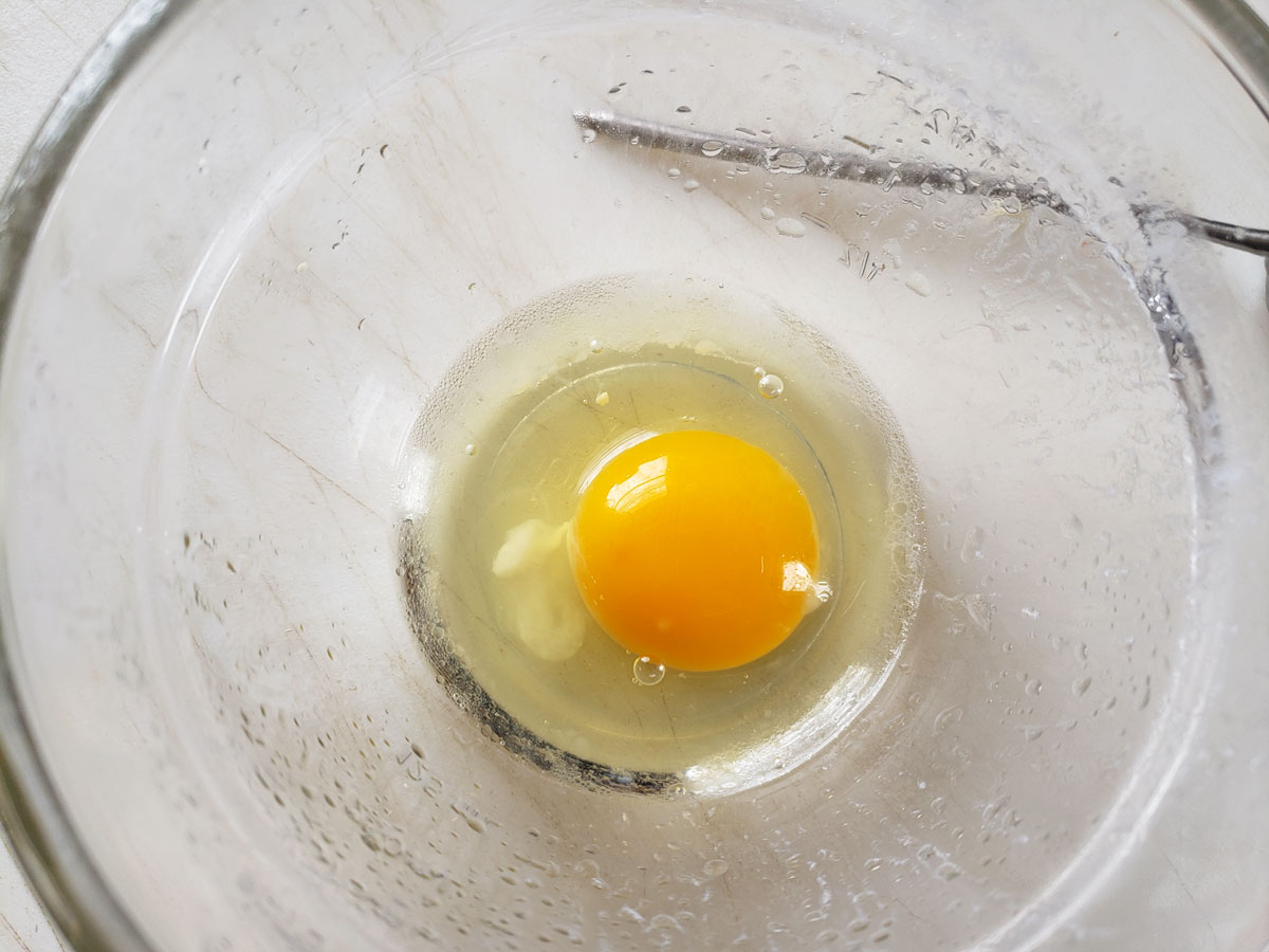 Whole egg in a small bowl.