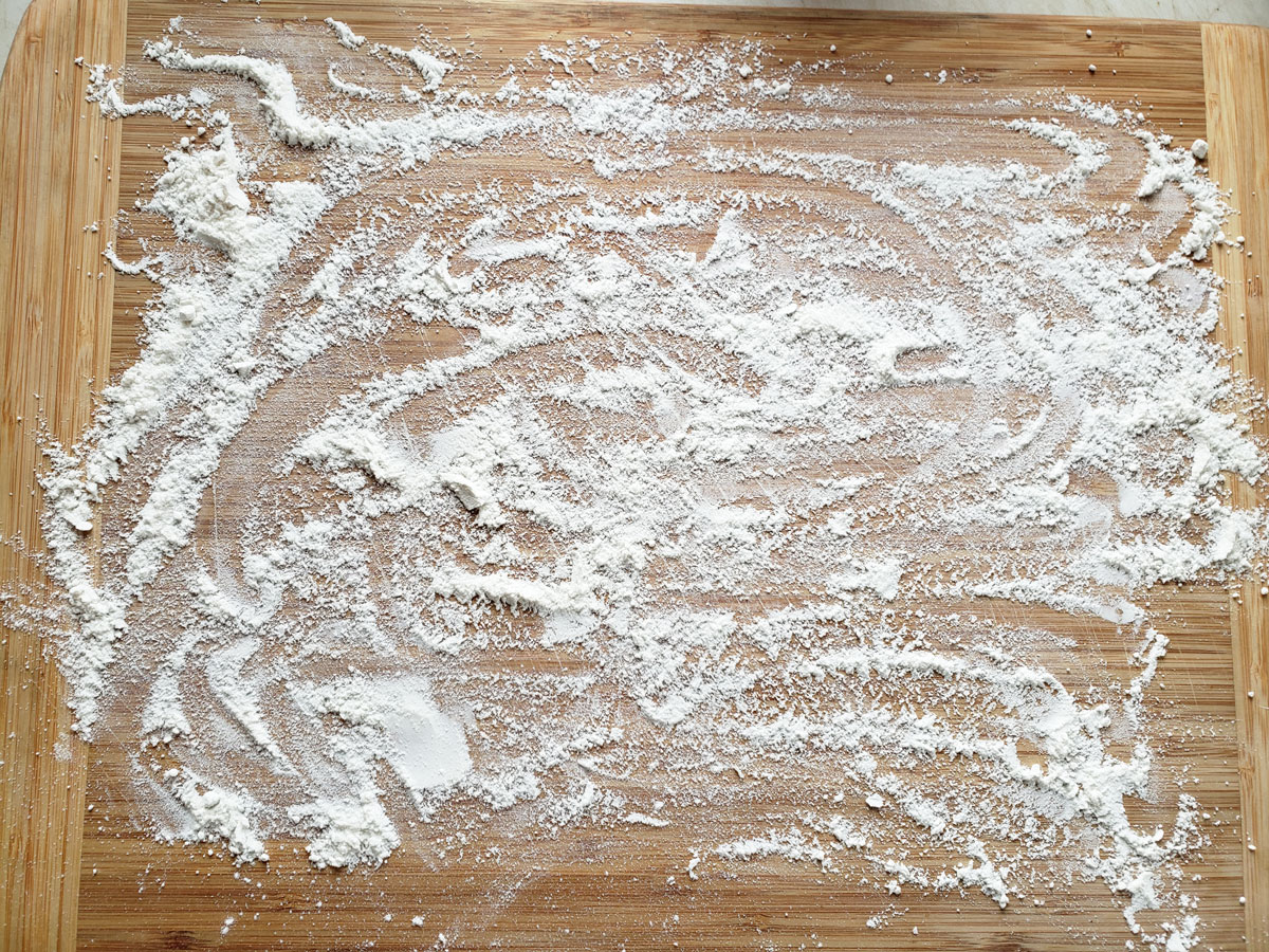 Flour sprinkled onto a large board 