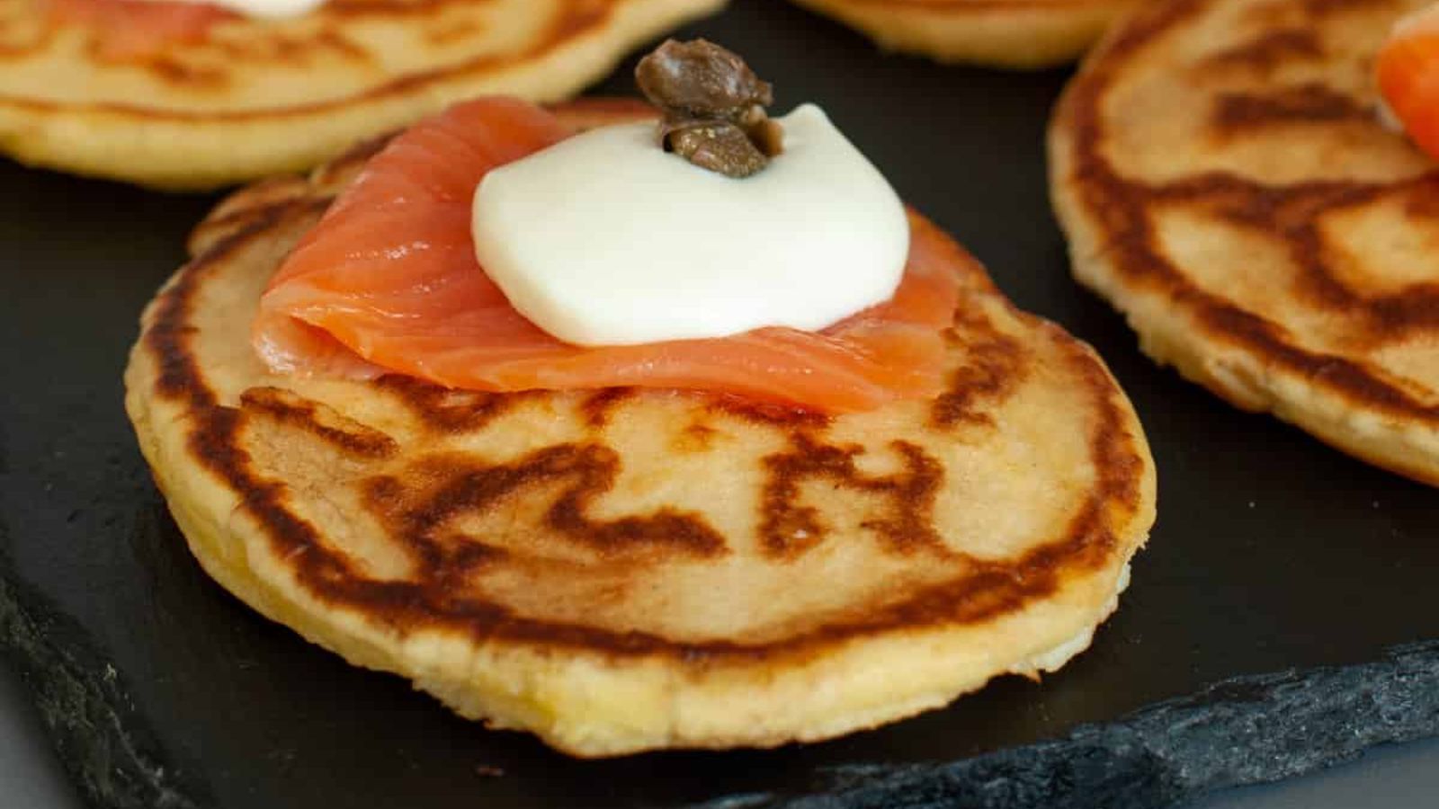 Pancakes with salmon on top.
