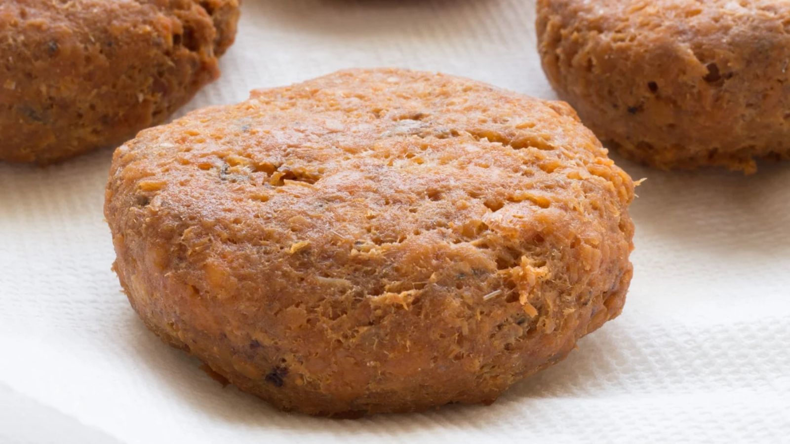 Salmon patties on a white background.