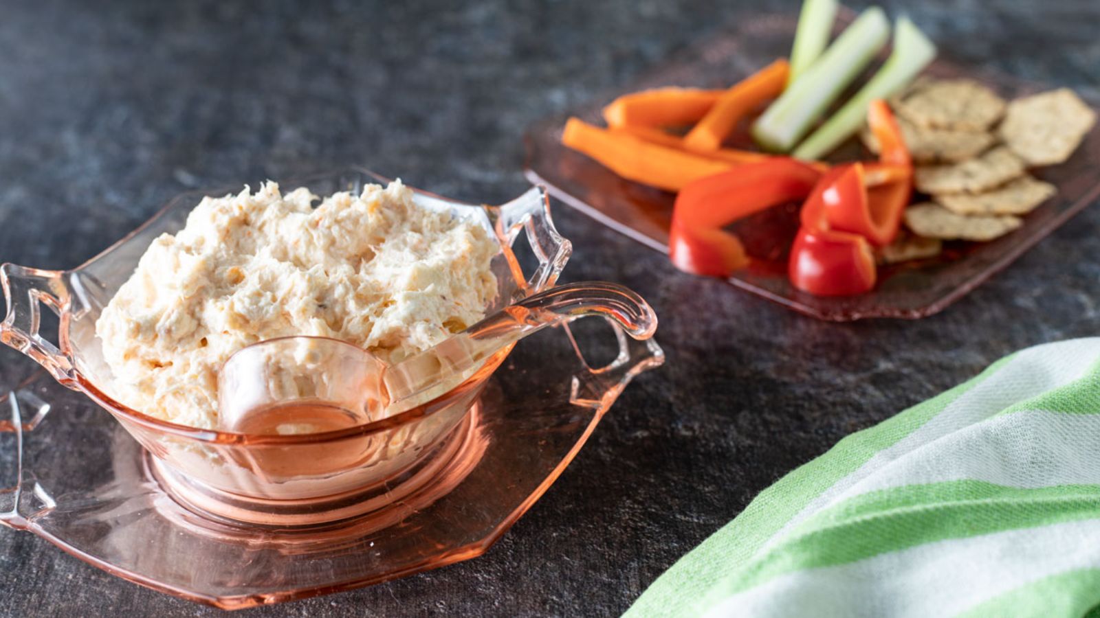 Dip in bowl. Crackers and vegetables on a serving plate.
