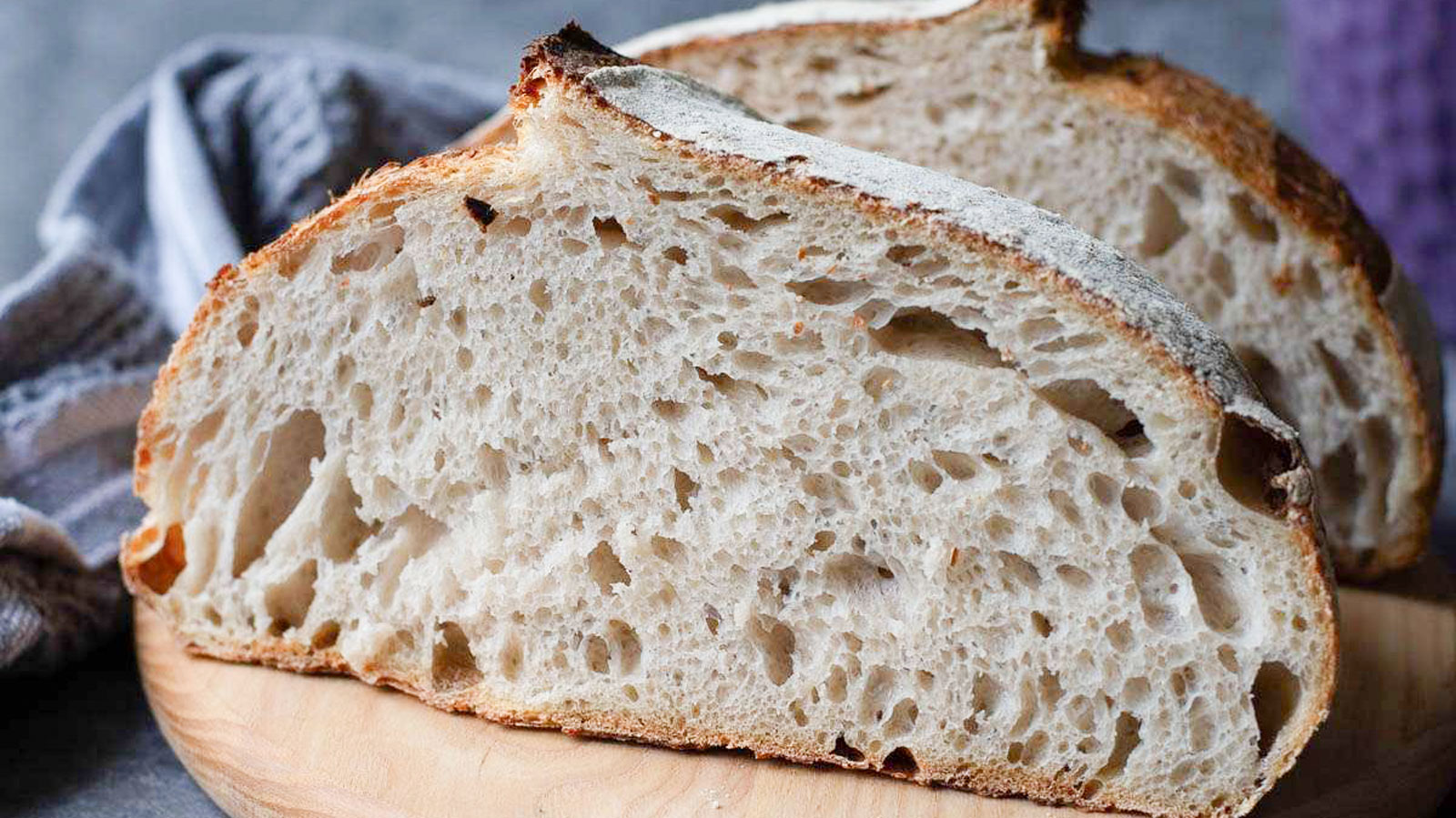 Beautiful sliced sourdough bread on a wooden board.