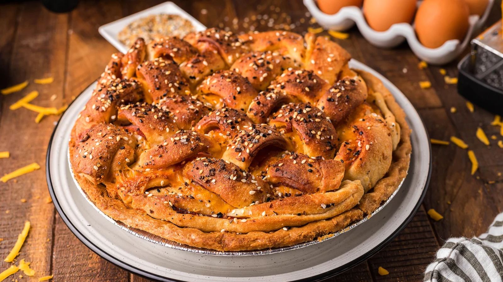 Ham and cheese quiche on a plate.