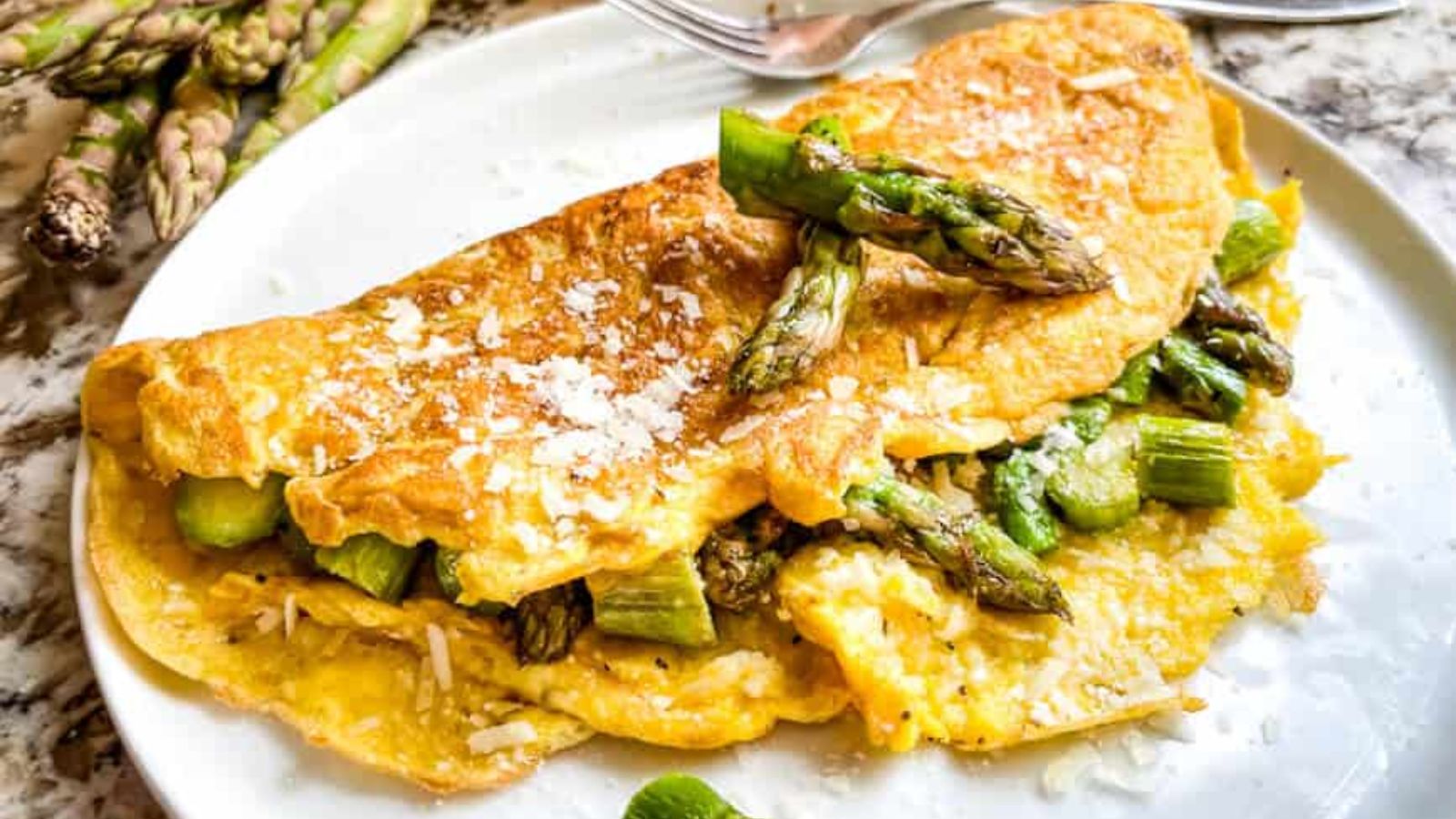 Asparagus omelette on a white plate.
