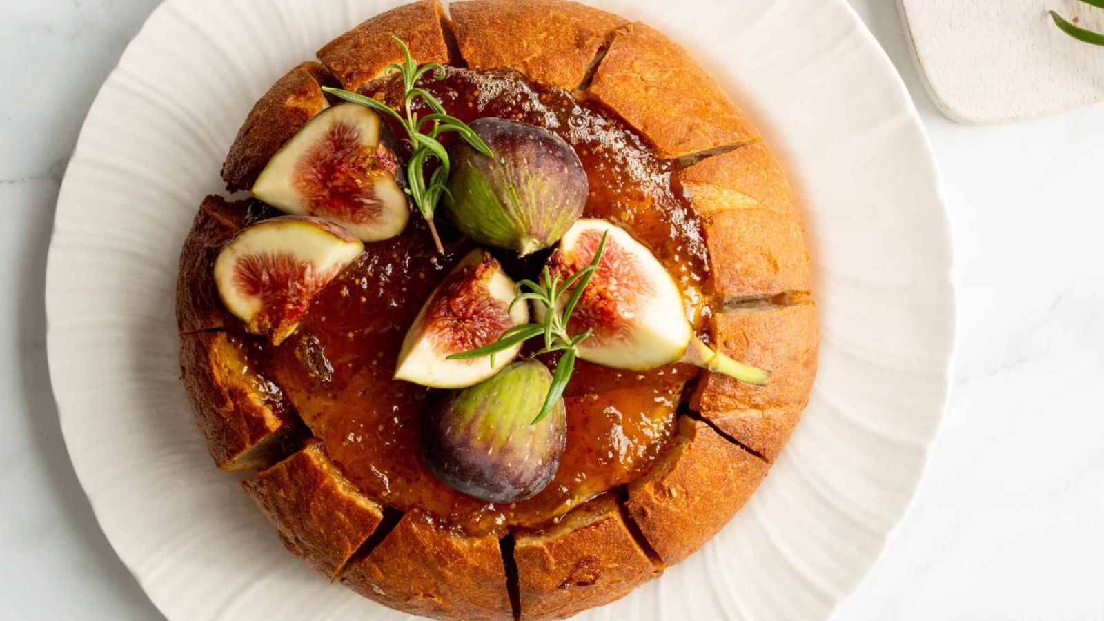 Bread bowl baked brie on a plate.
