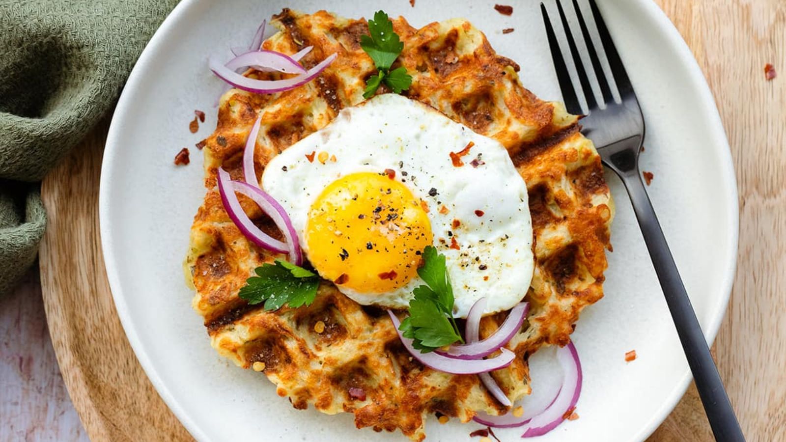 Waffle with egg and onions on top.