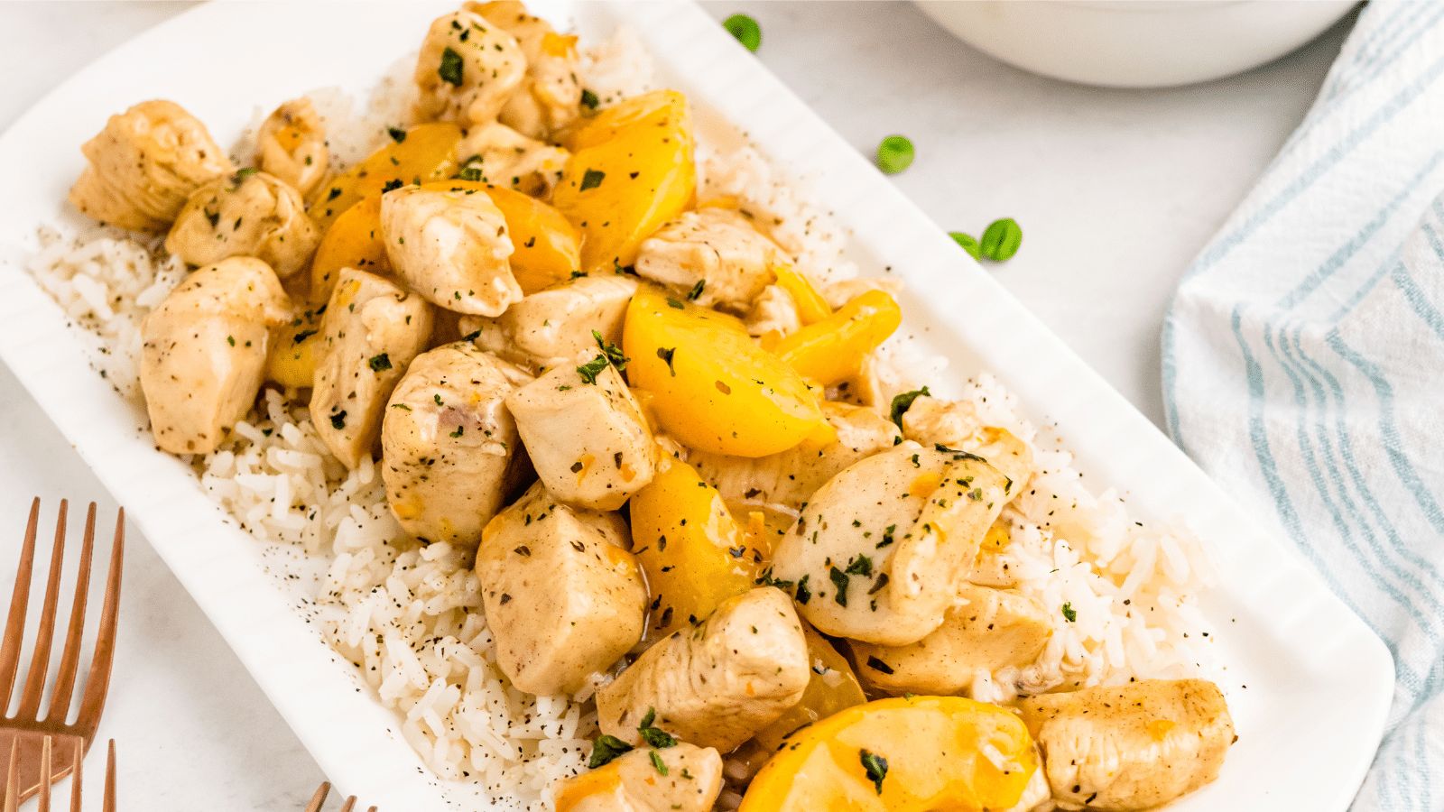 Chicken and peaches on a plate.