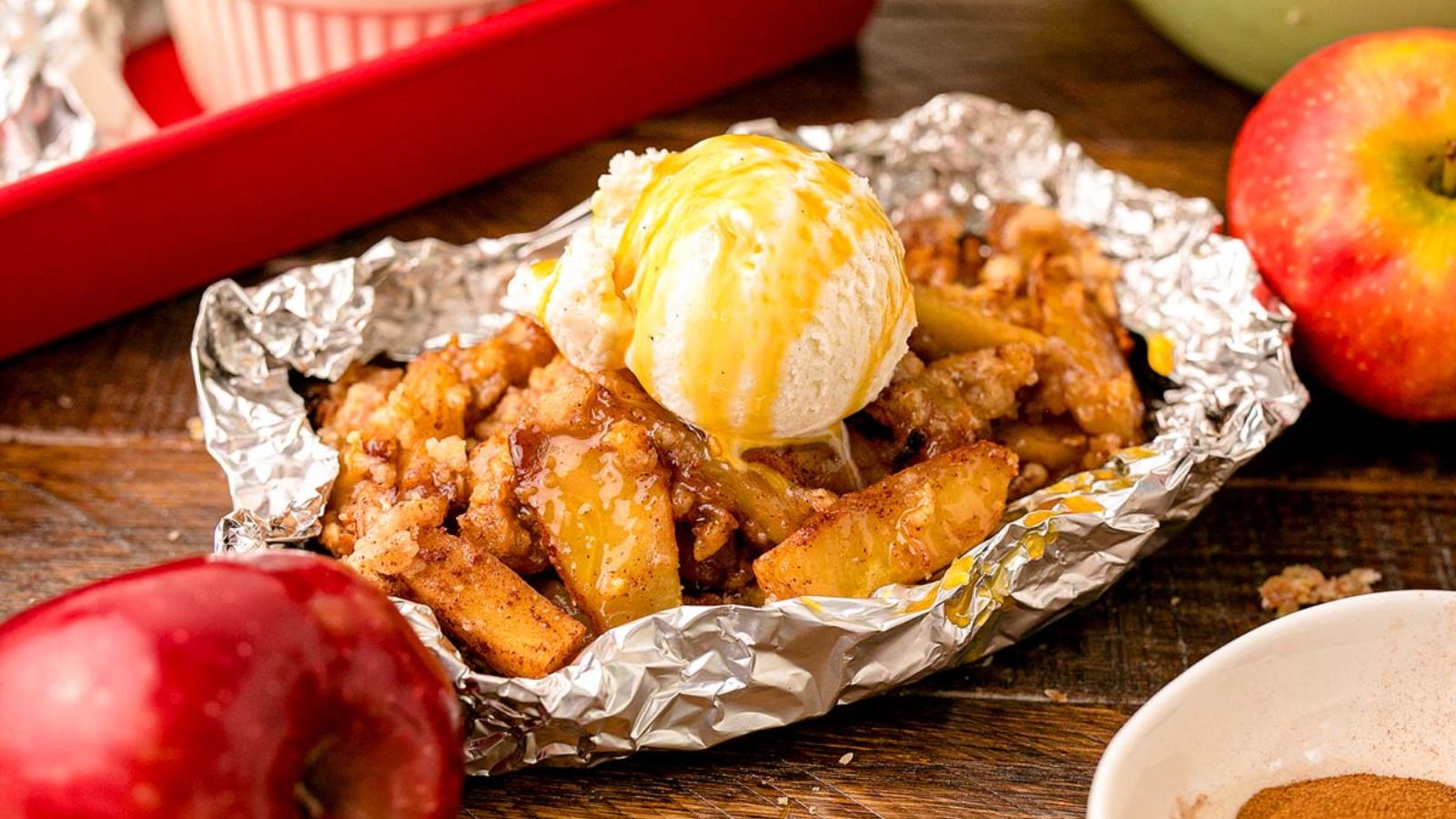 Apple crisp with a scoop of ice cream on top.