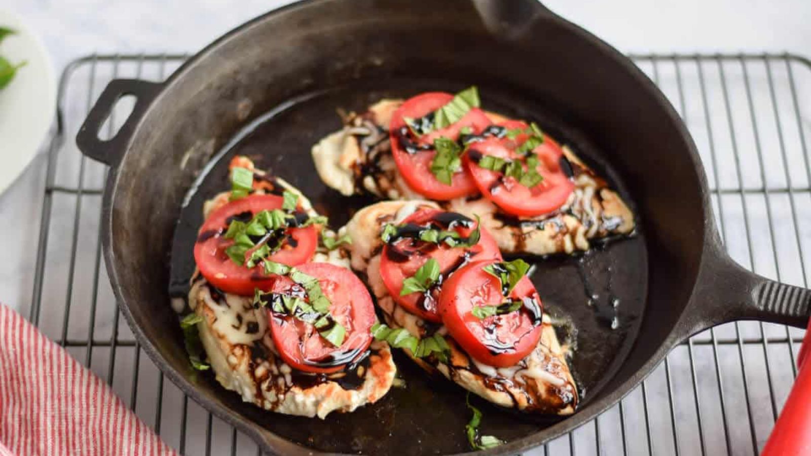 Caprese chicken in a pan.