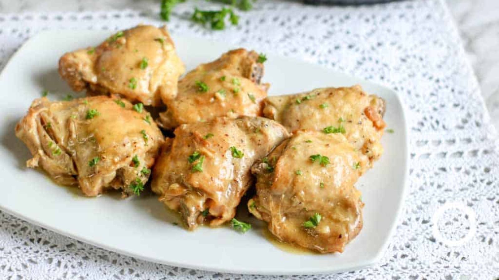 Chicken thighs with mustard sauce on a plate.