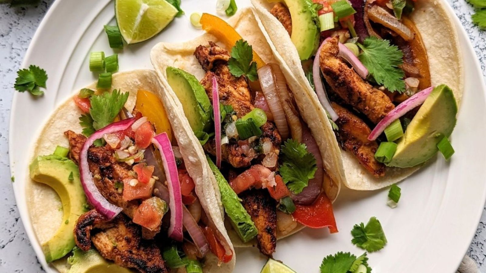 Chicken fajitas on a plate.
