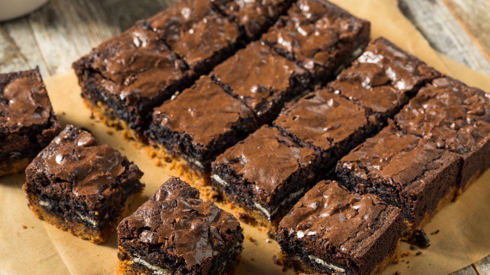 Cut brownies on a beige surface.