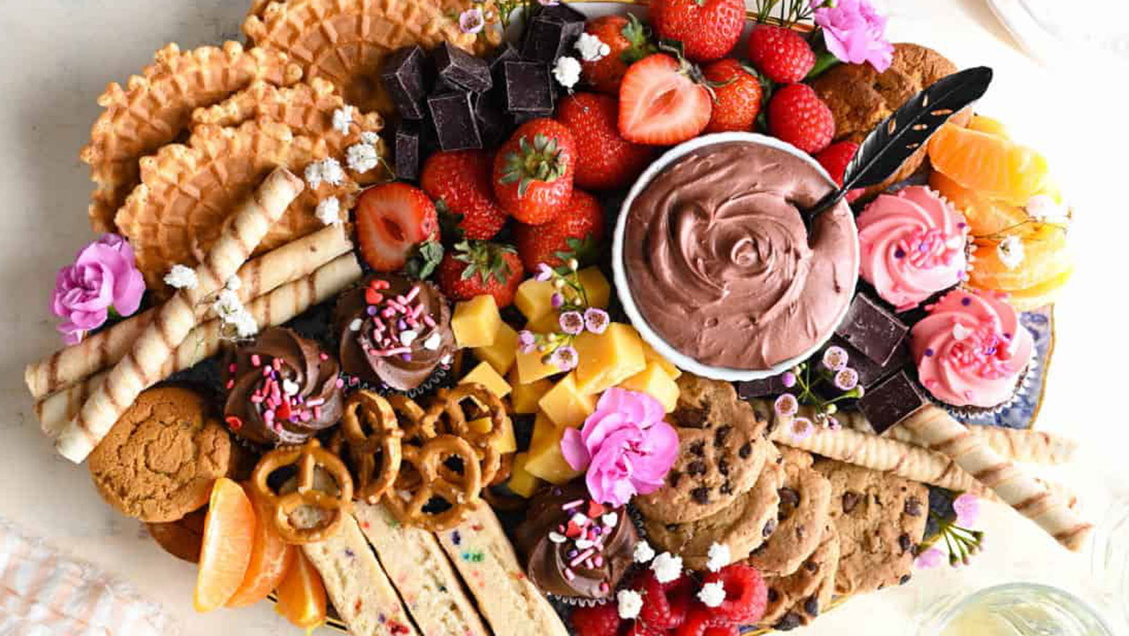 Assorted fruits and baked goods on a serving platter.