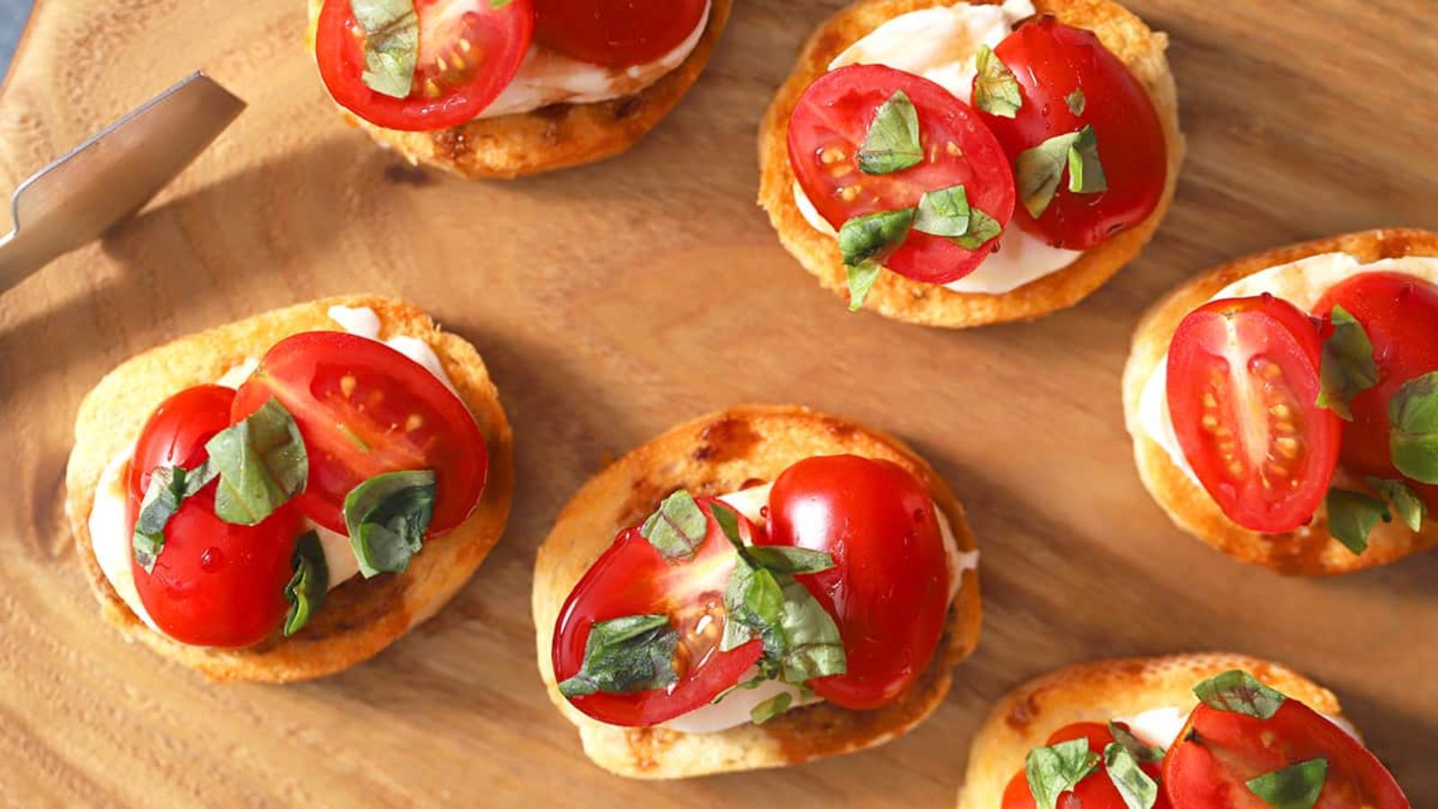 Crostini appetizer on a wooden board.