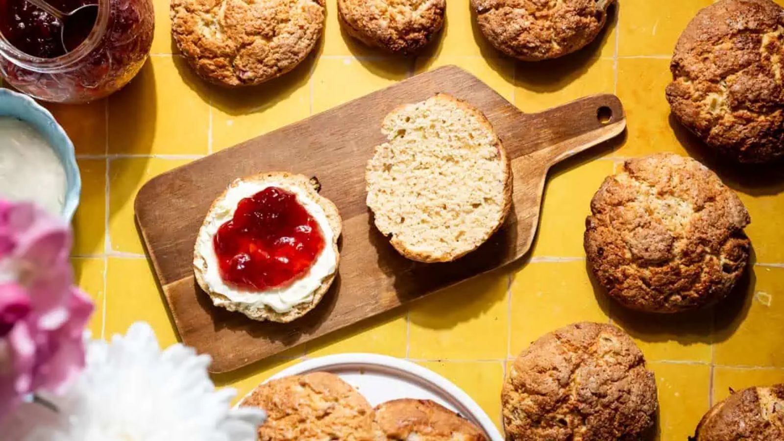 Rhubarb and ginger scones with stem ginger on a board. 