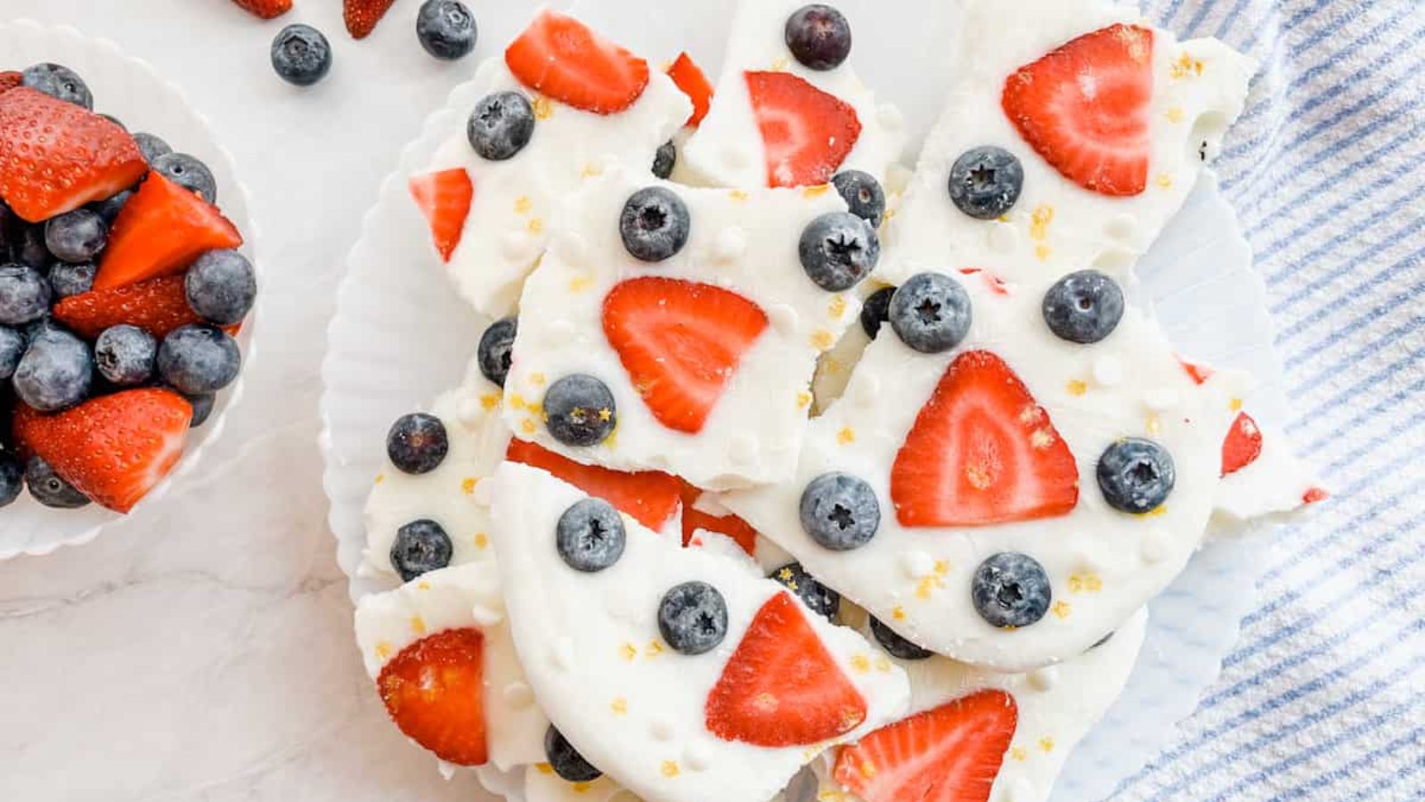 Frozen yogurt bark with berries on a plate.