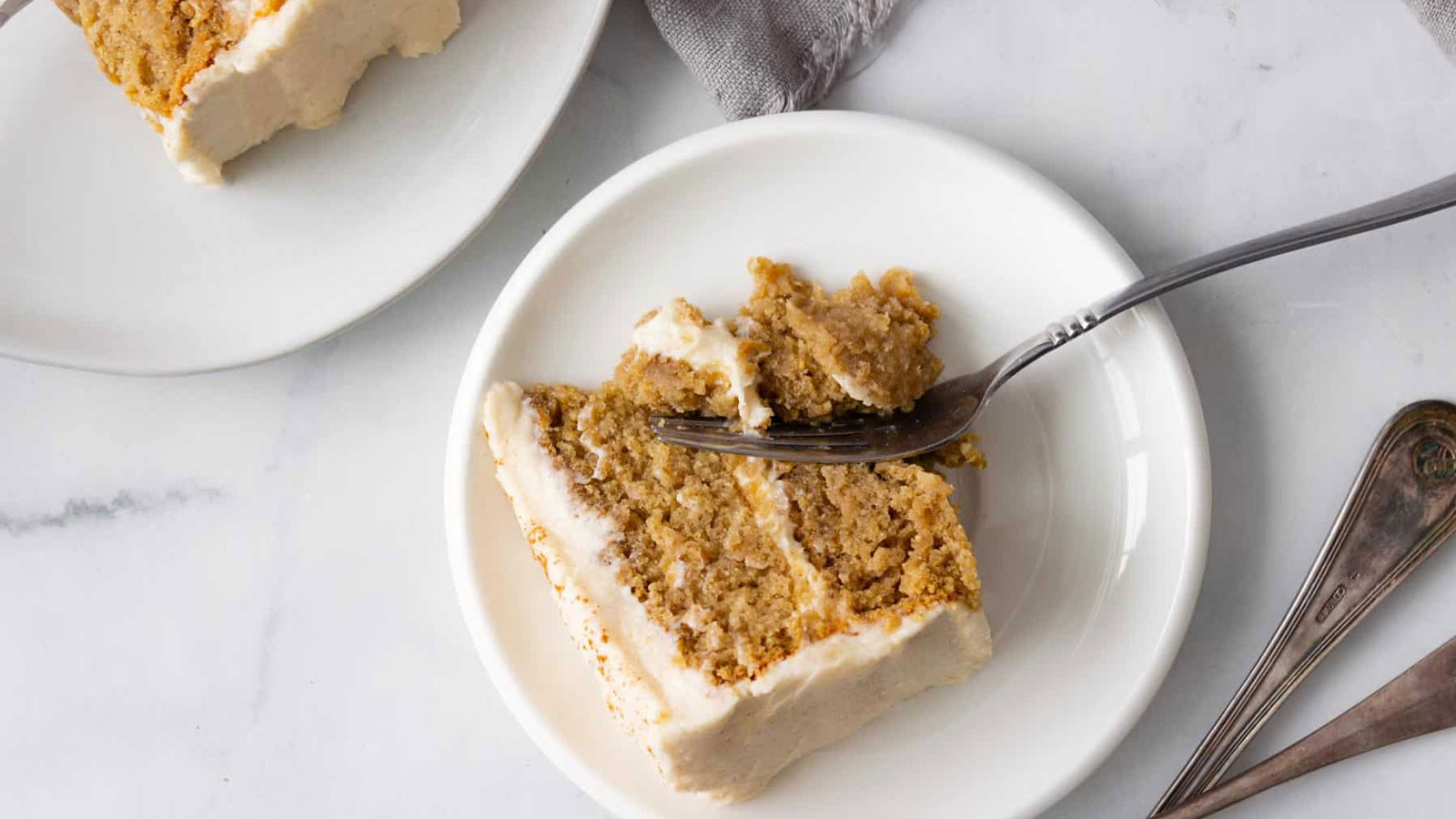 Slice of layered oatmeal cake on a white plate.
