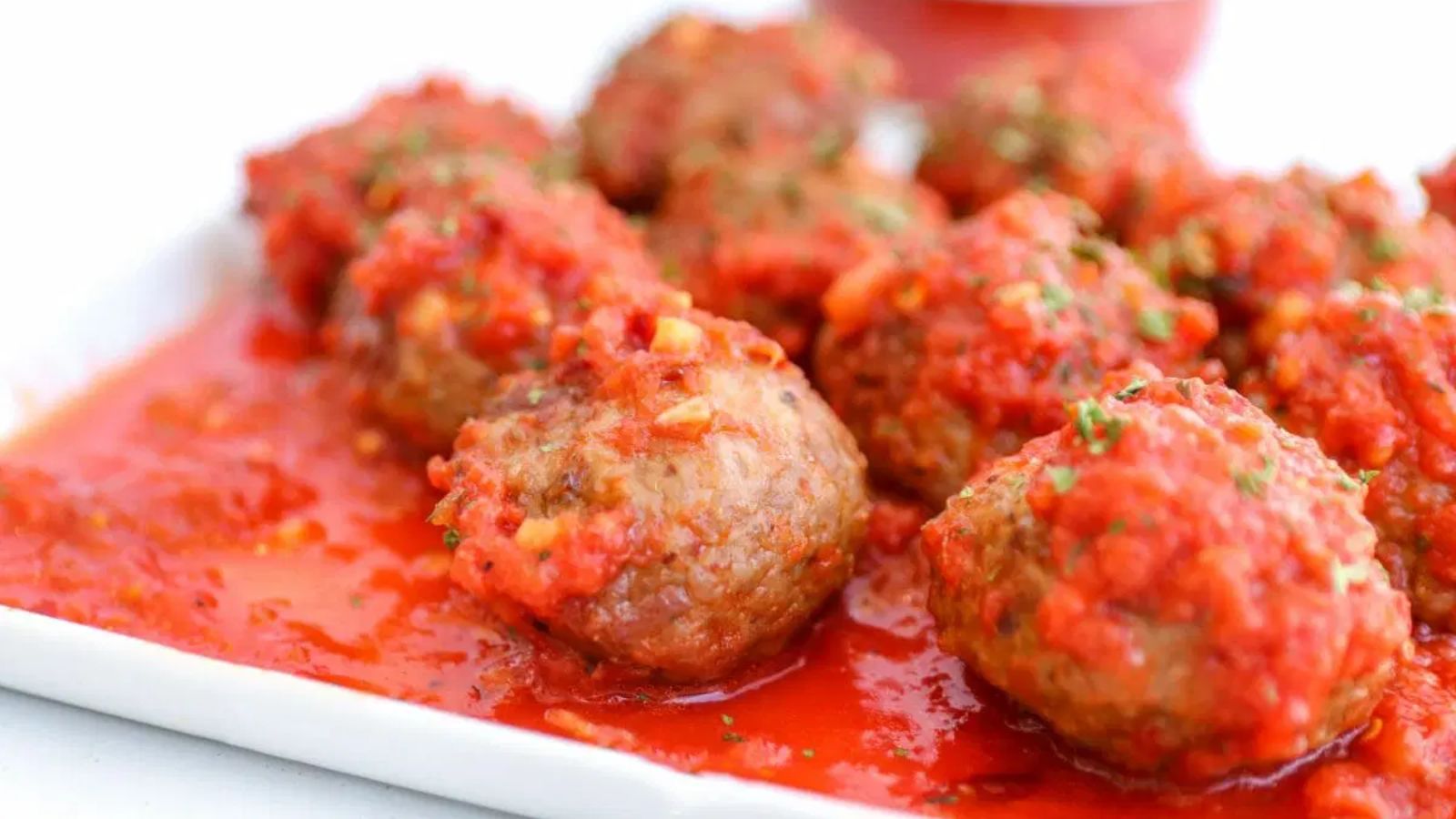 Italian style meatballs with sauce on a plate.