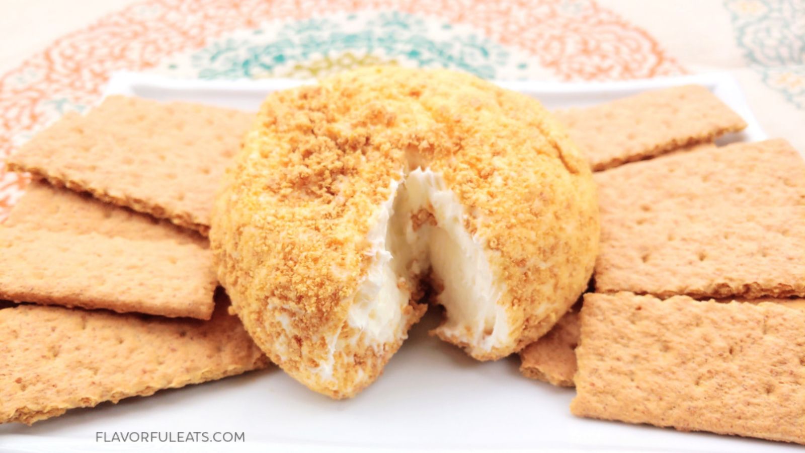 Lemon cheesecake cheese ball on a plate.