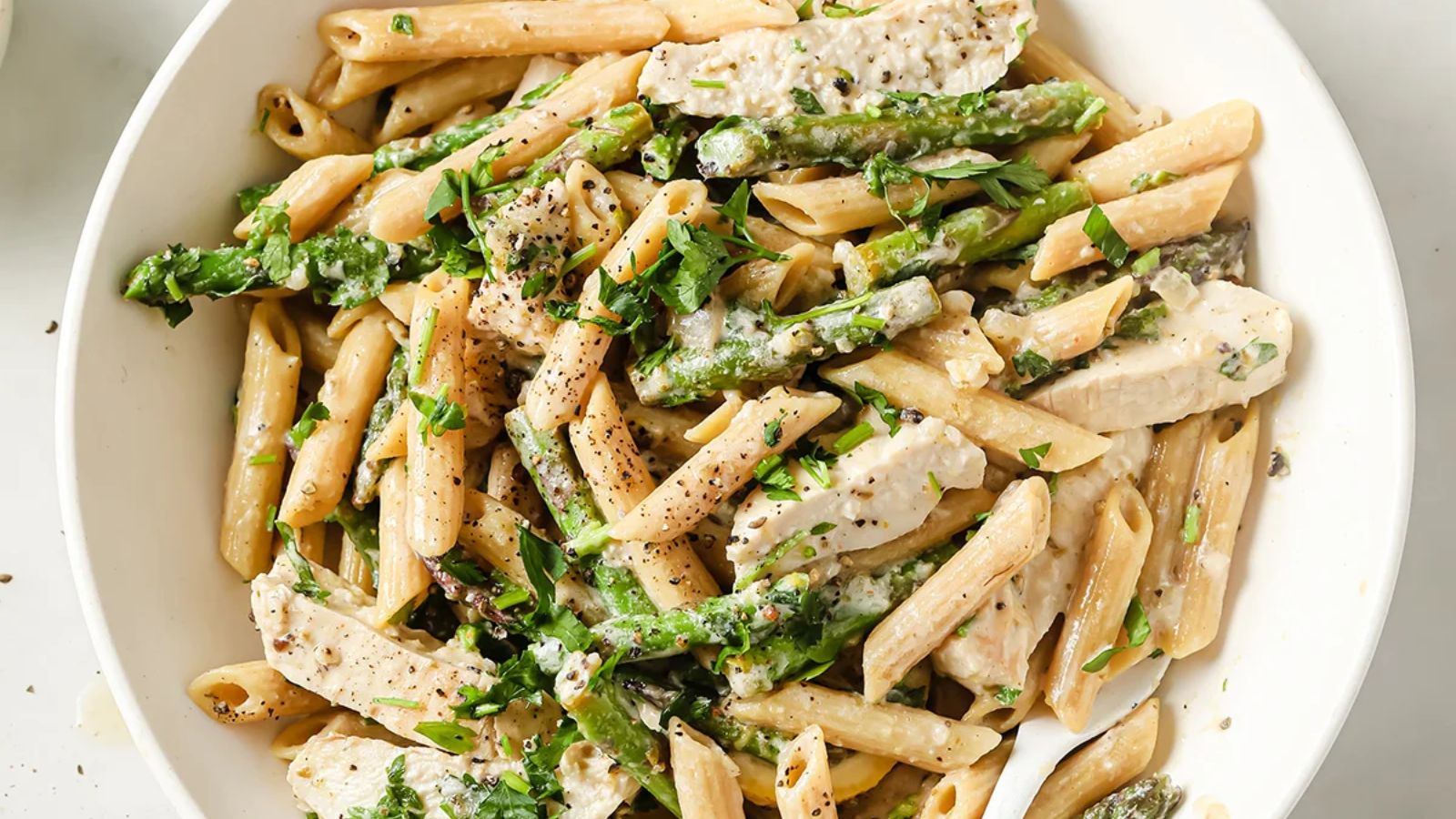 Pasta with asparagus and lemon in a bowl.