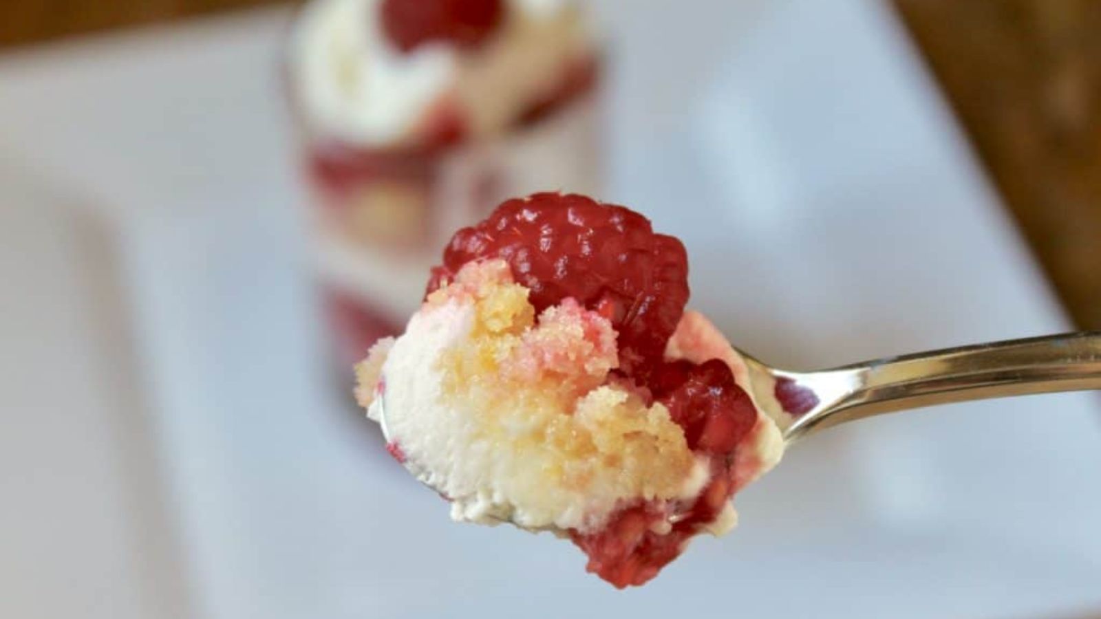 Raspberry trifle on a spoon.