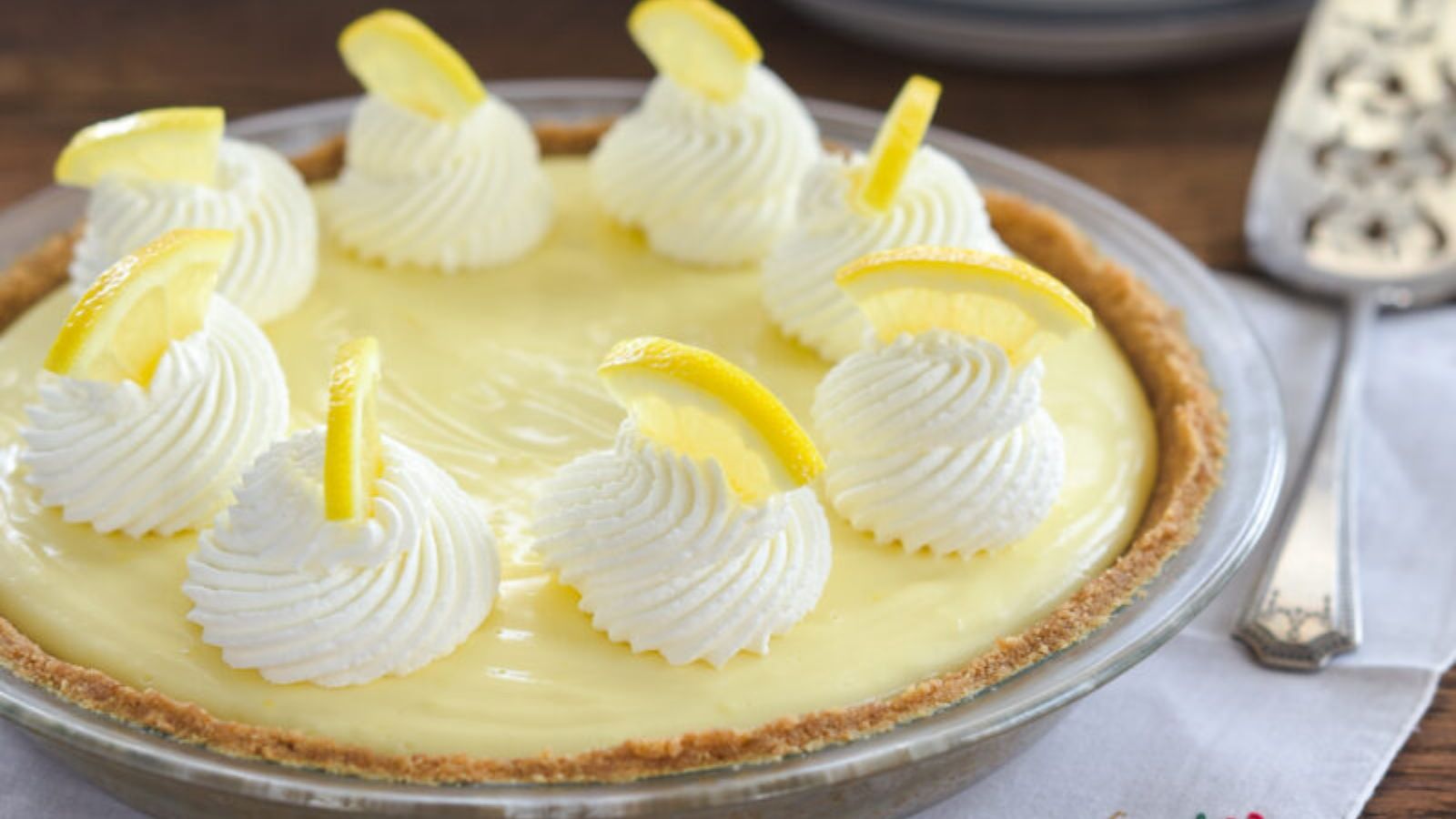 Sour cream lemon pie on a glass tray.