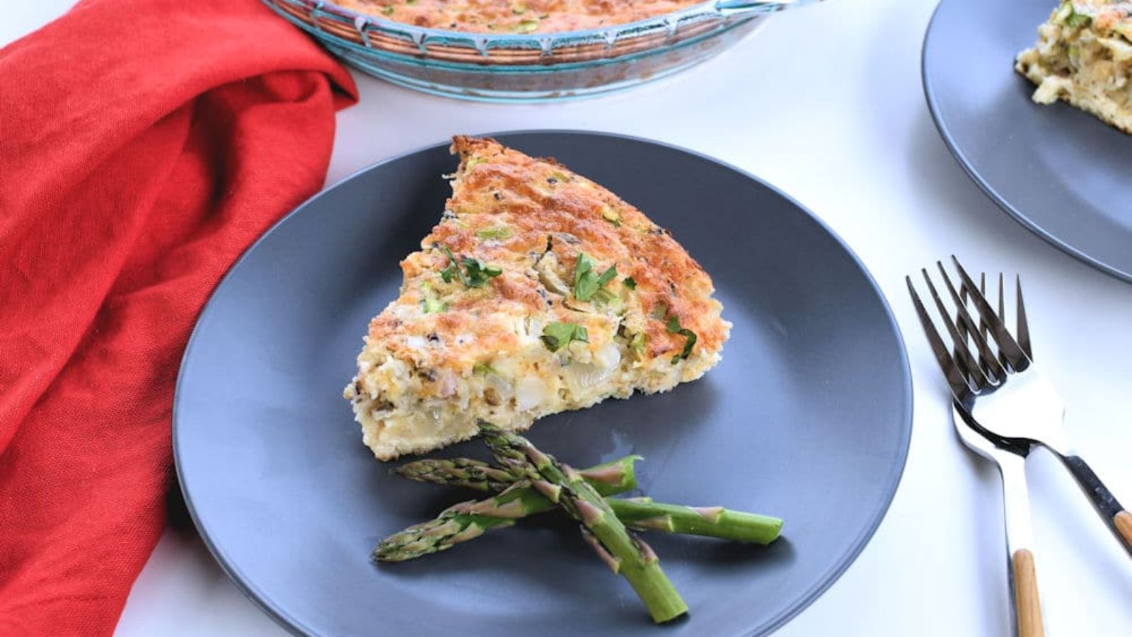 Ham and asparagus quiche on a plate.