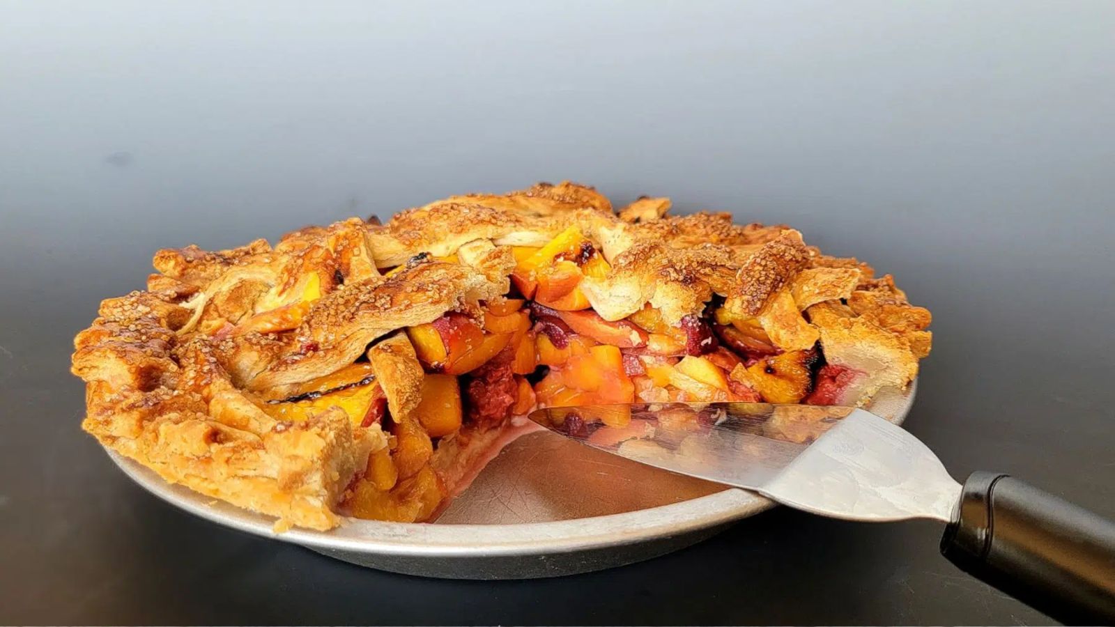 Peach pie with a slice.