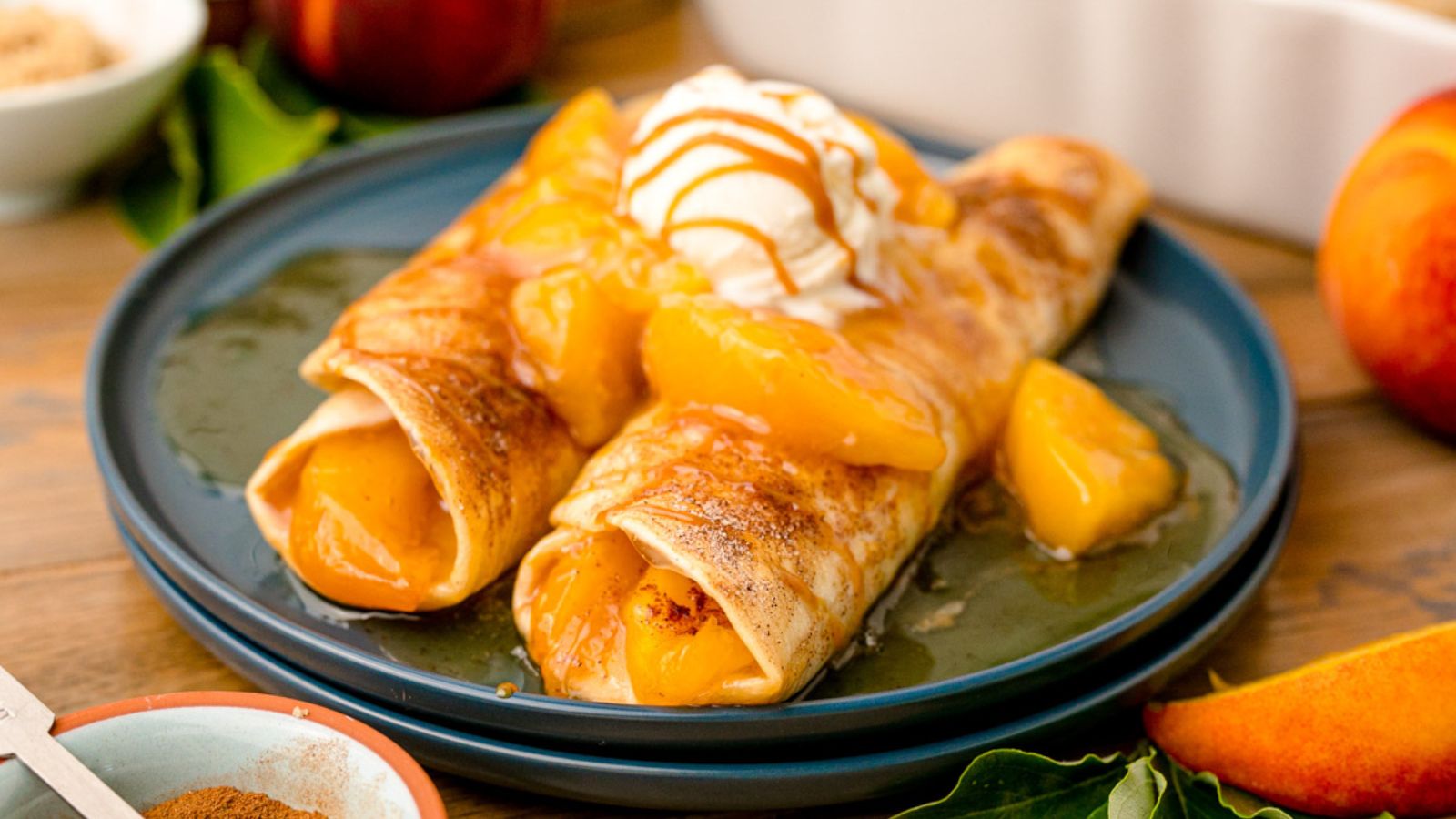 Peach pie enchiladas on a plate.
