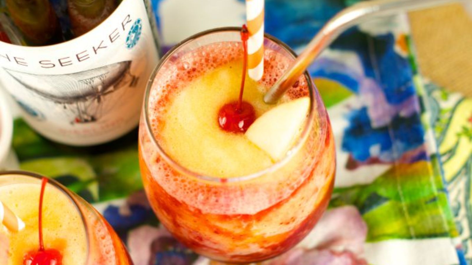 Peach and cherry slushy in a glass.