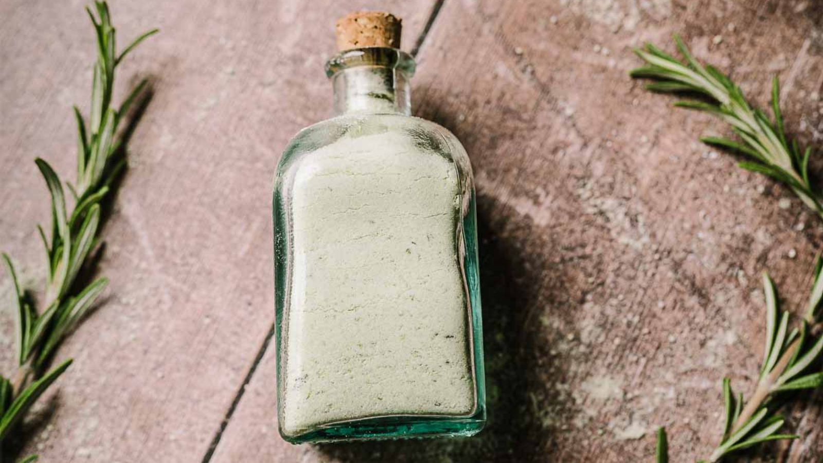 Rosemary salt in a glass bottle.