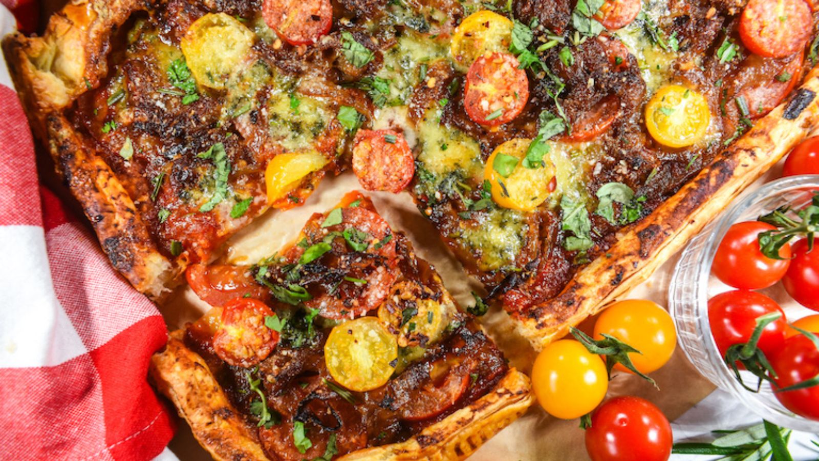 Tomato tart with cherry tomatoes on the side.