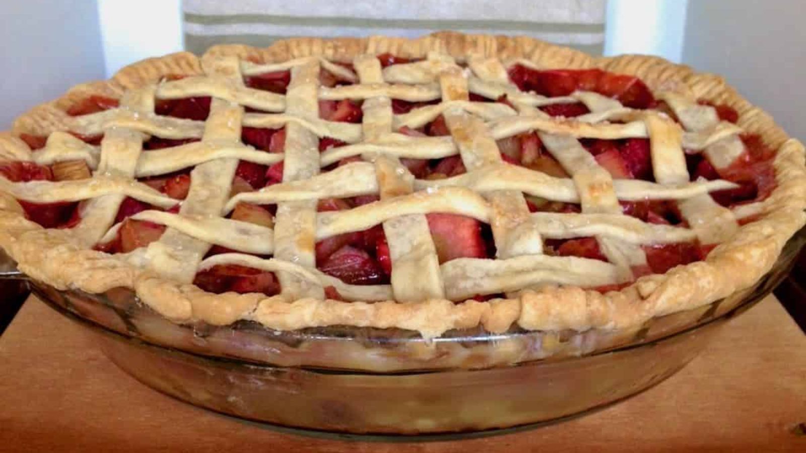 Whole strawberry rhubarb lattice pie.