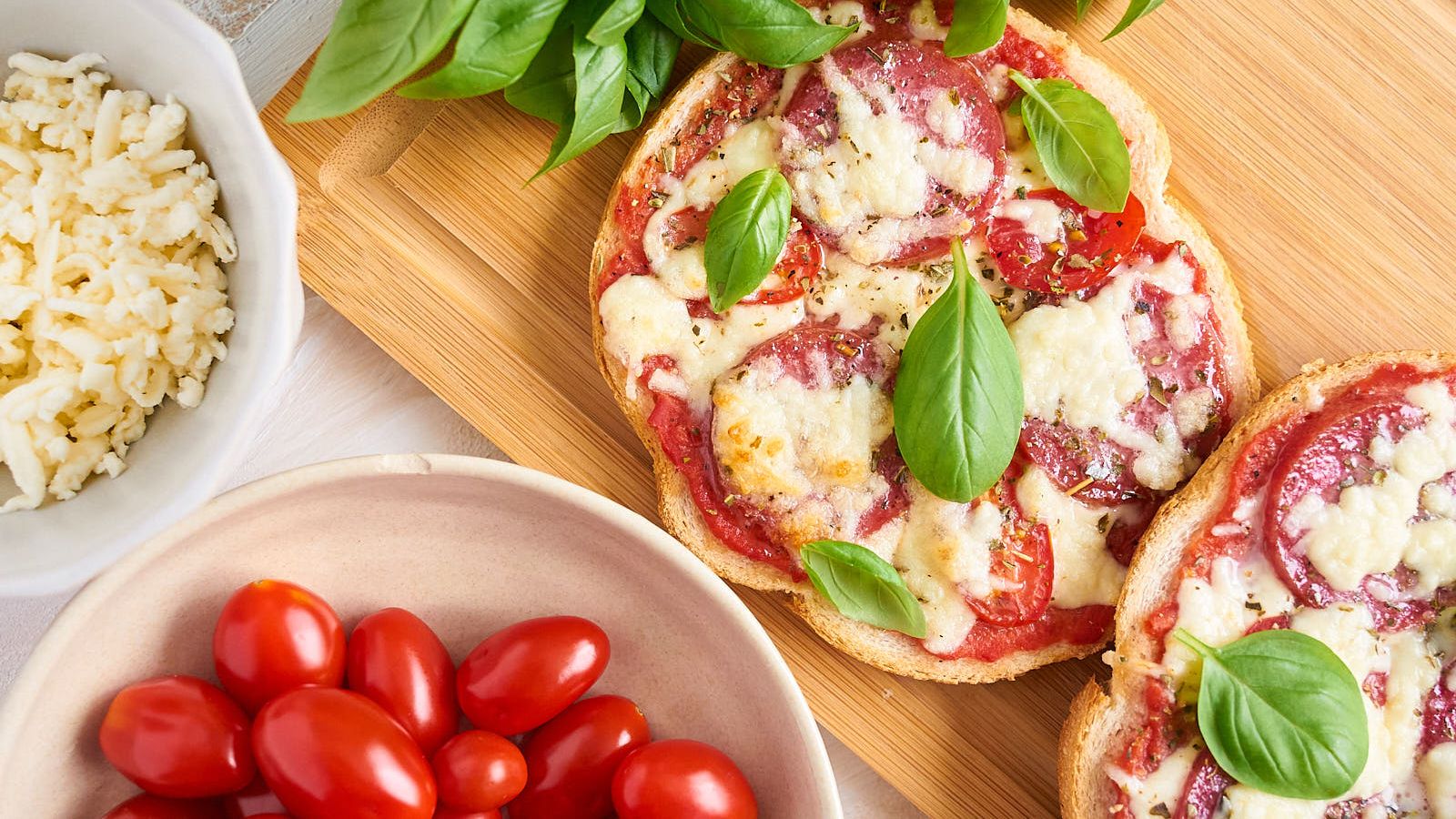 Salami pizza toast on a wooden board.