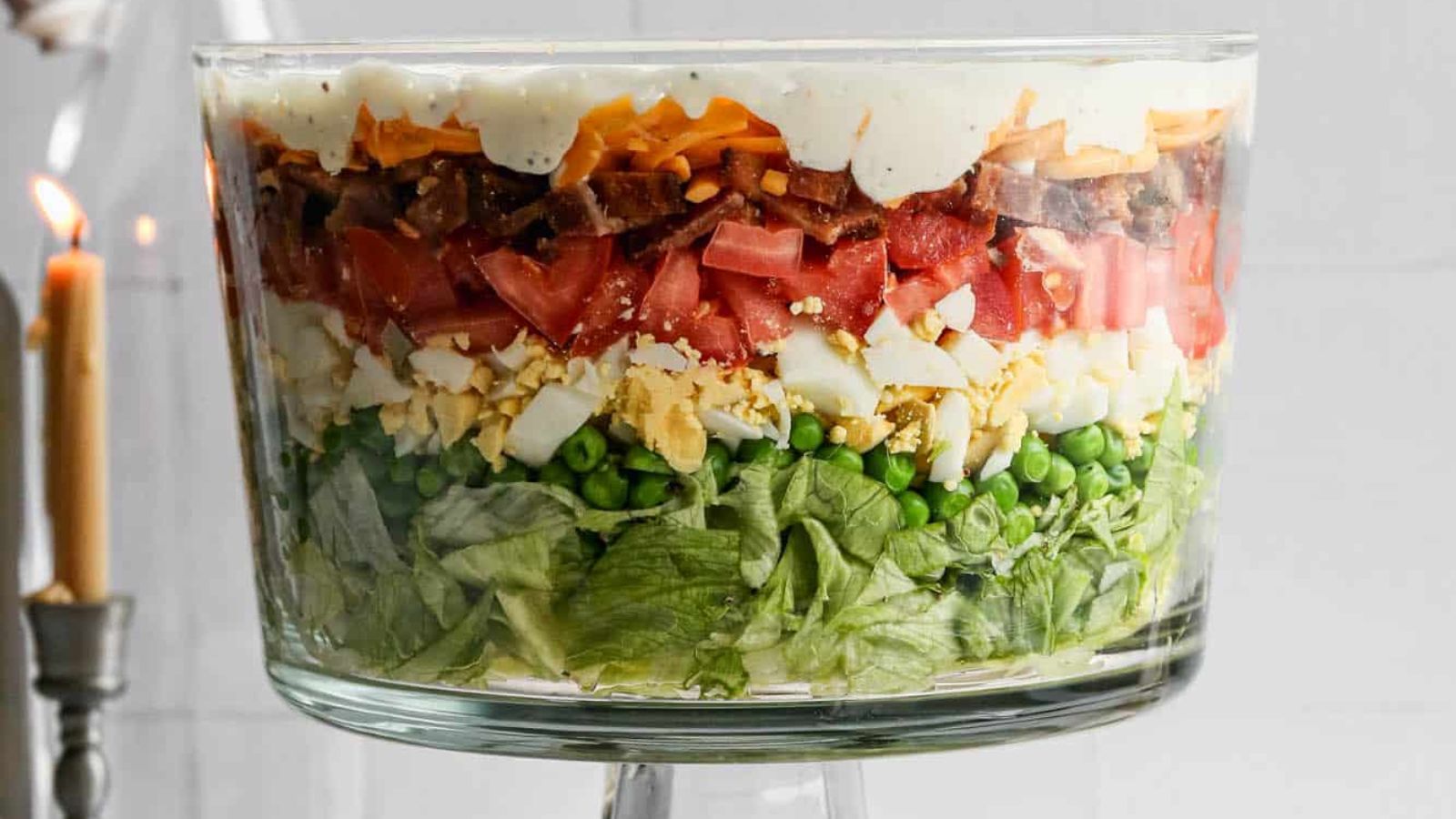 Seven layer salad in a transparent bowl.