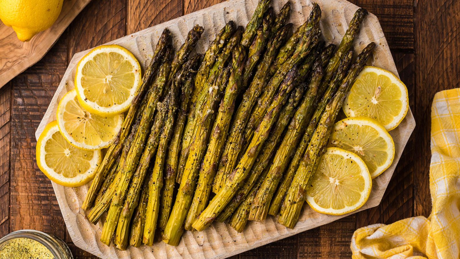 Smoked asparagus with lemon on a plate.