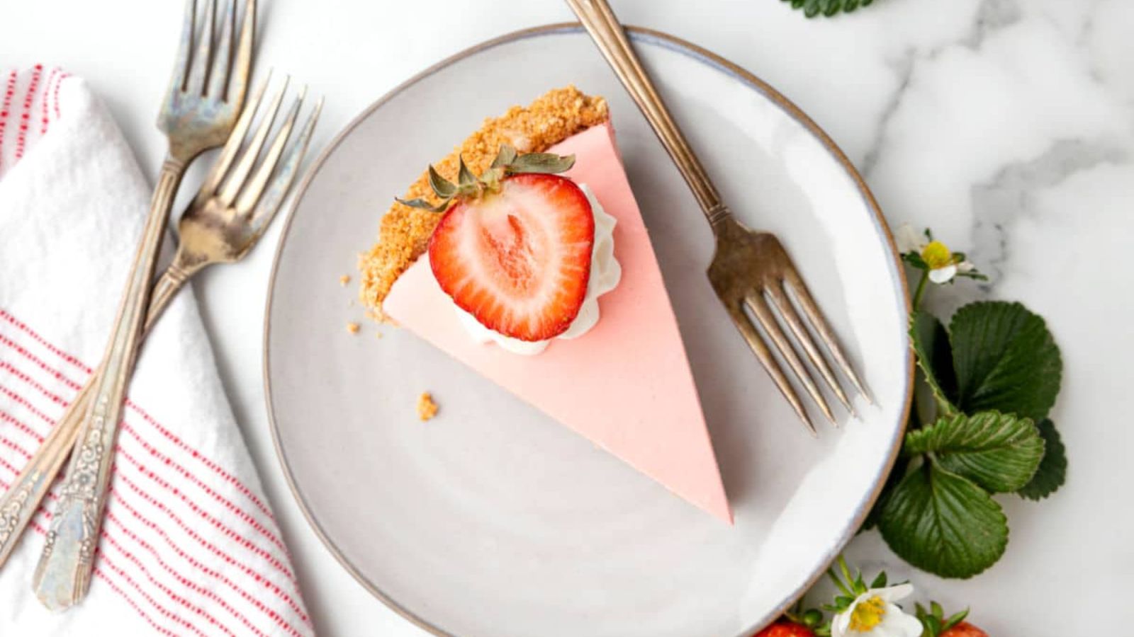 A slice of strawberry cake on a plate.