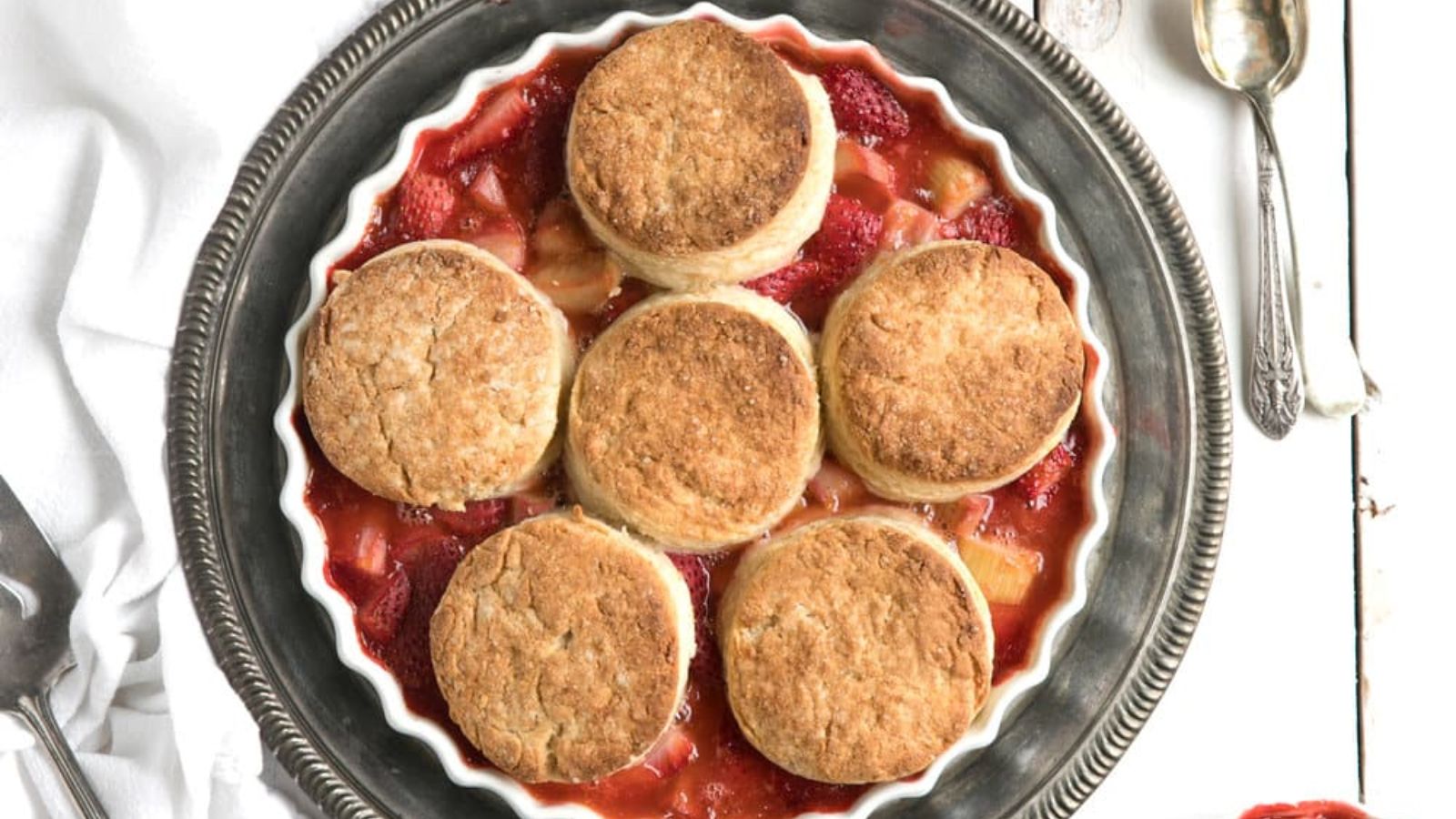 Strawberry rhubarb cobbler on a plate.