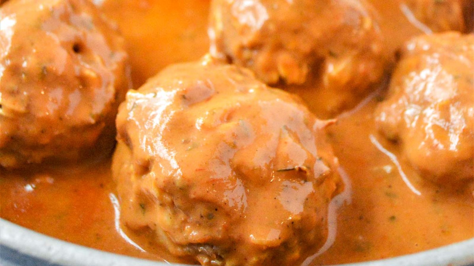 Close up shot of meatballs with sauce.
