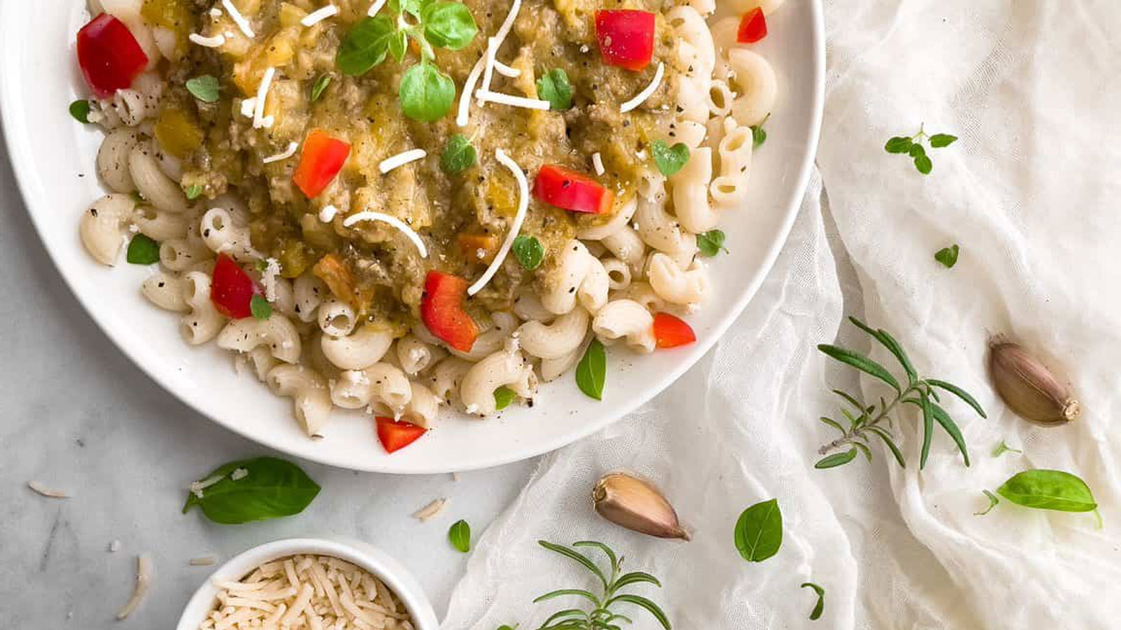 Fusilli topped with a squash pasta sauce on a white plate.