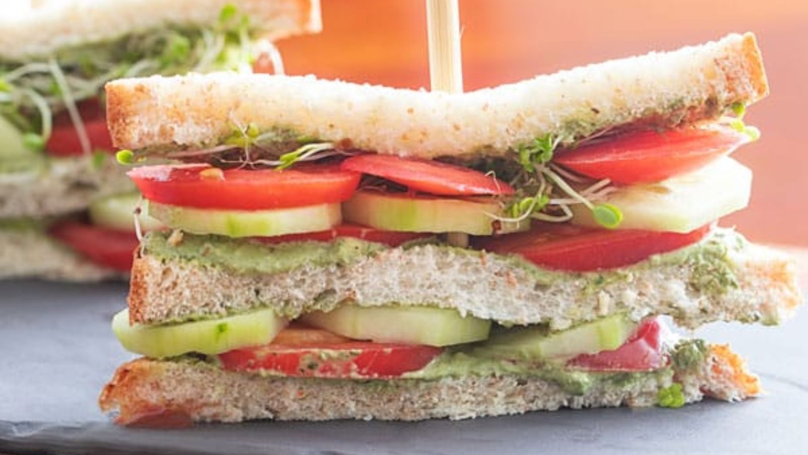 Tomato sandwich with stick.