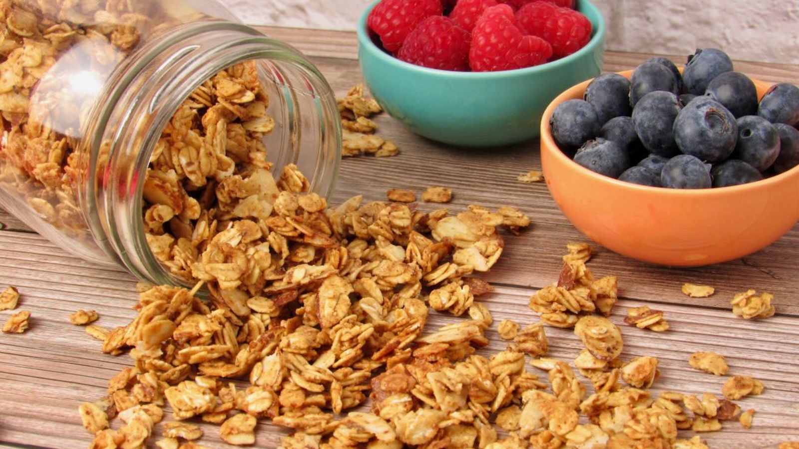 Granola with raspberries and blueberries on the side.