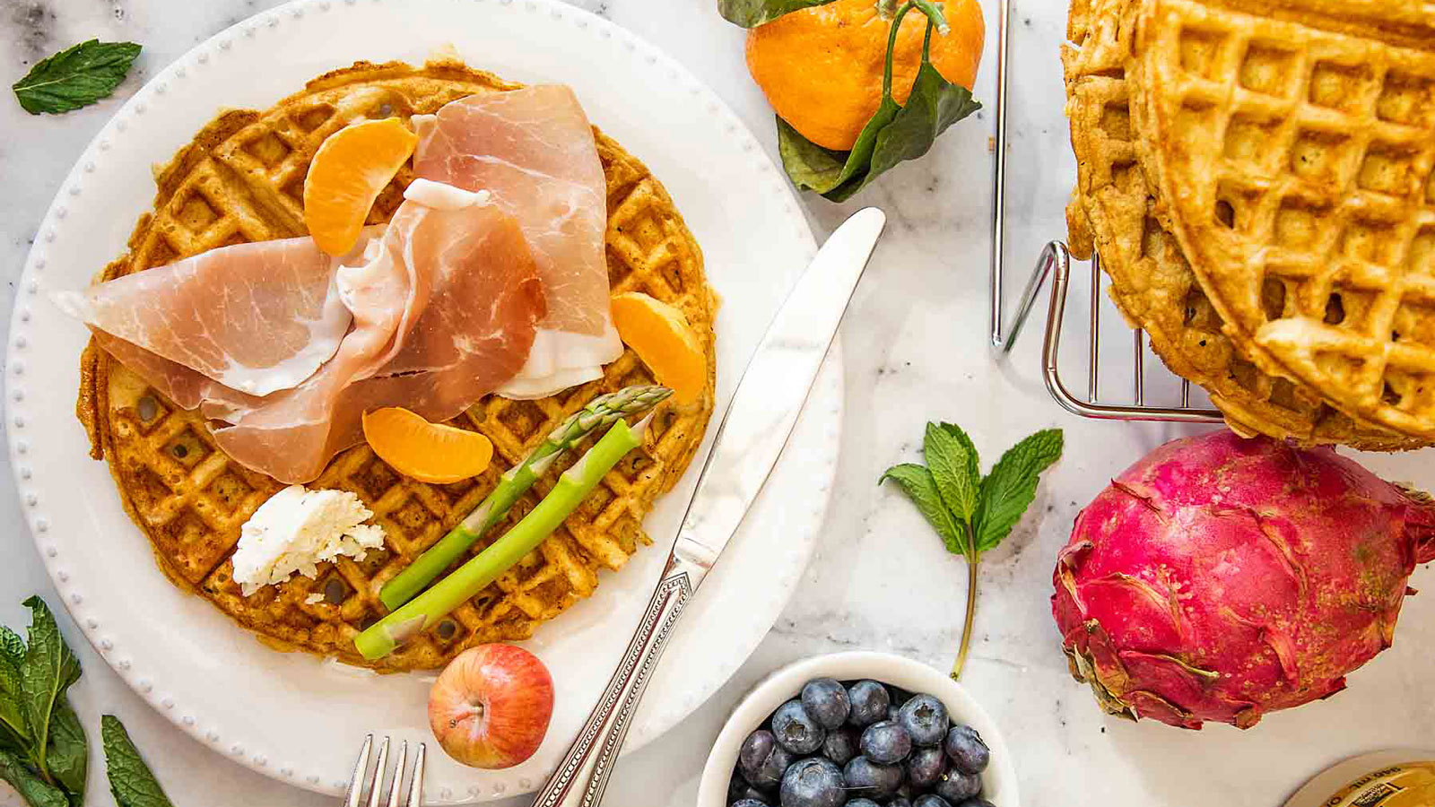 Waffles with toppings on a white board.