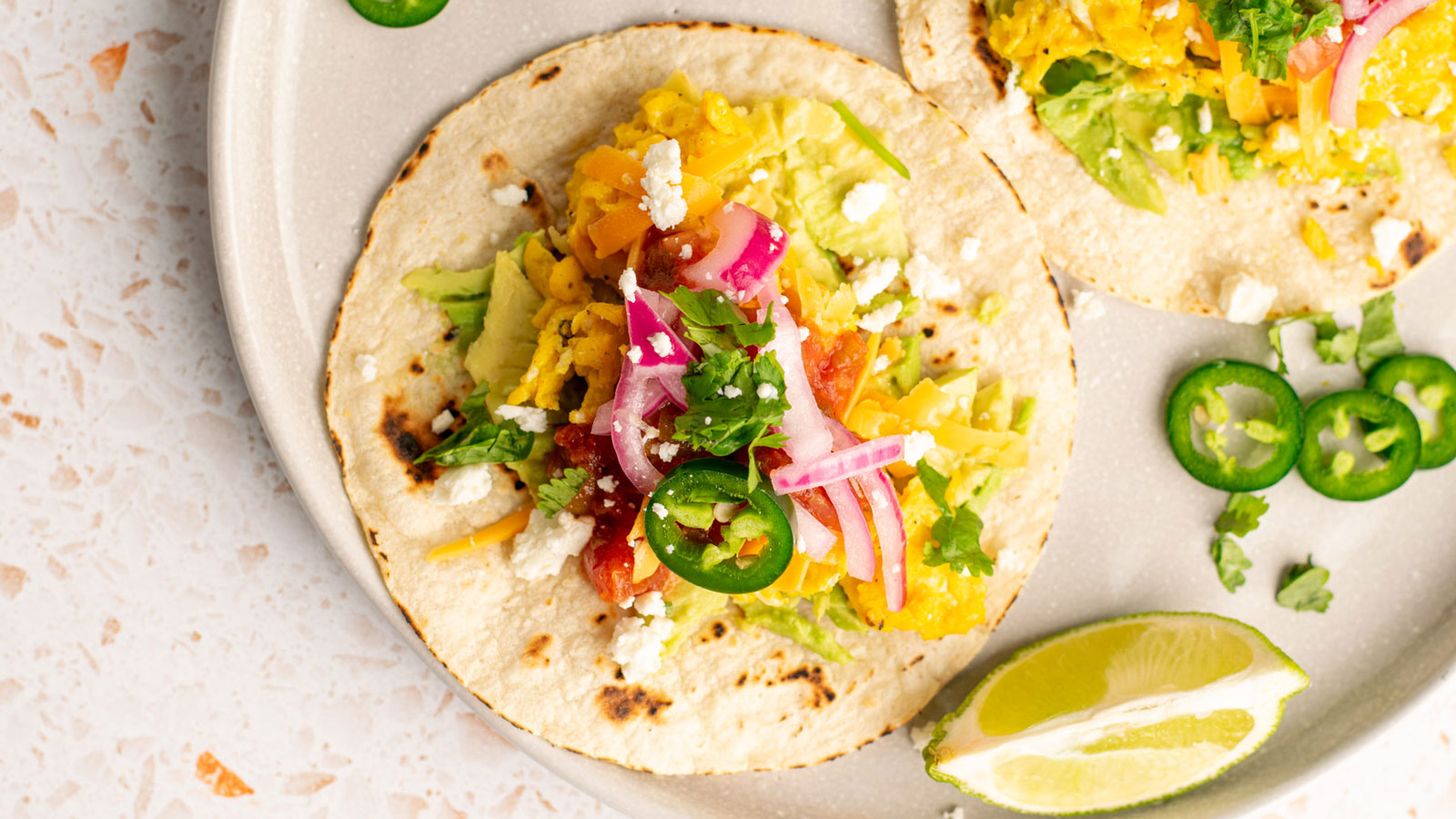 Breakfast tacos with fresh garnishes.