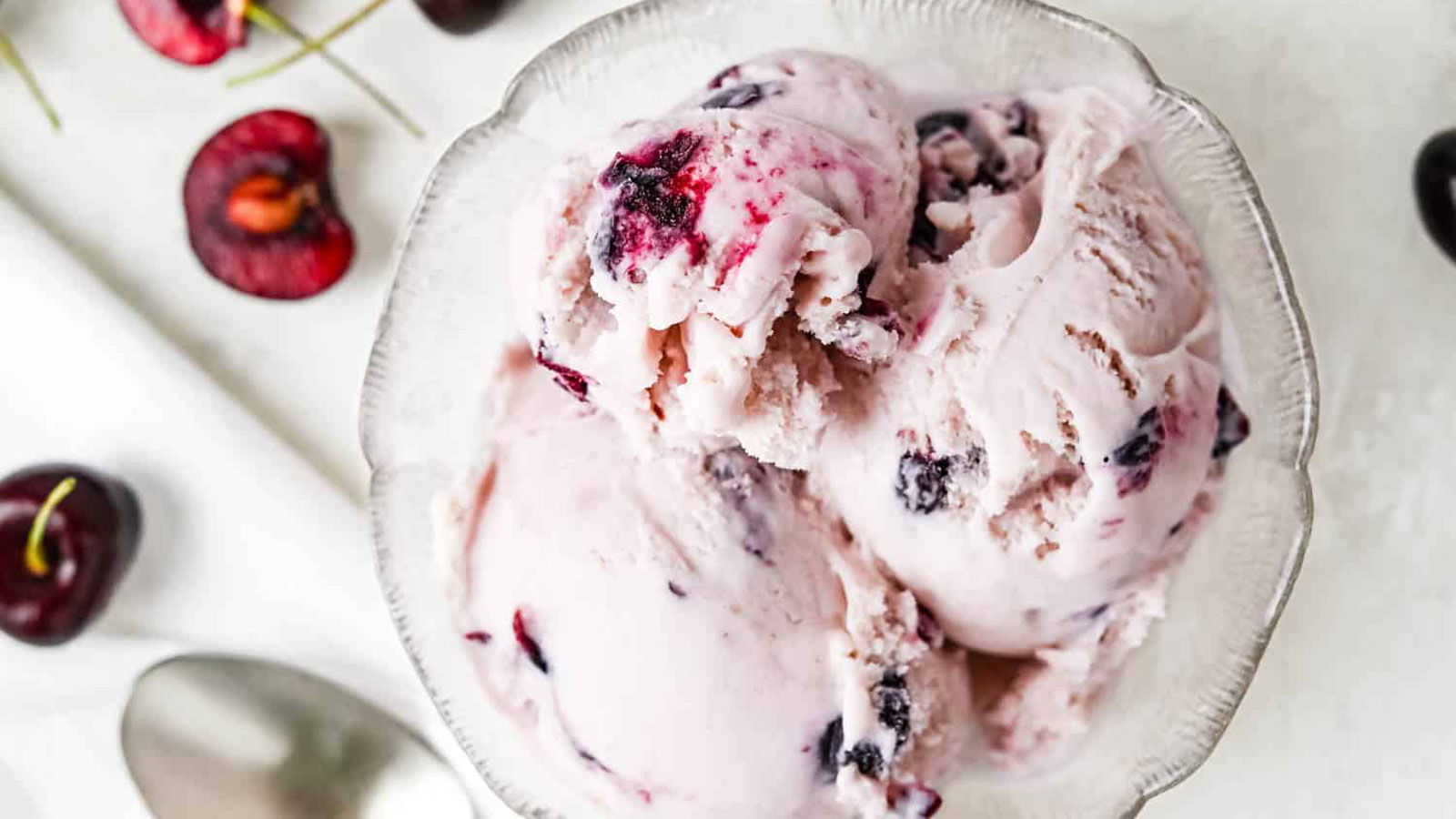 Cherry ice cream in a glass bowl.