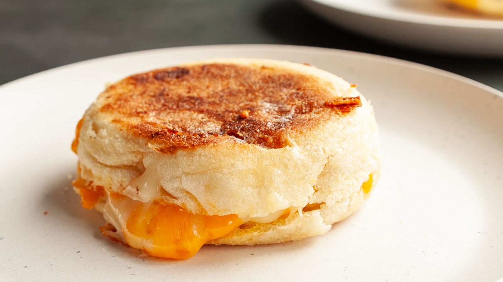 Muffin grilled cheese on a plate.