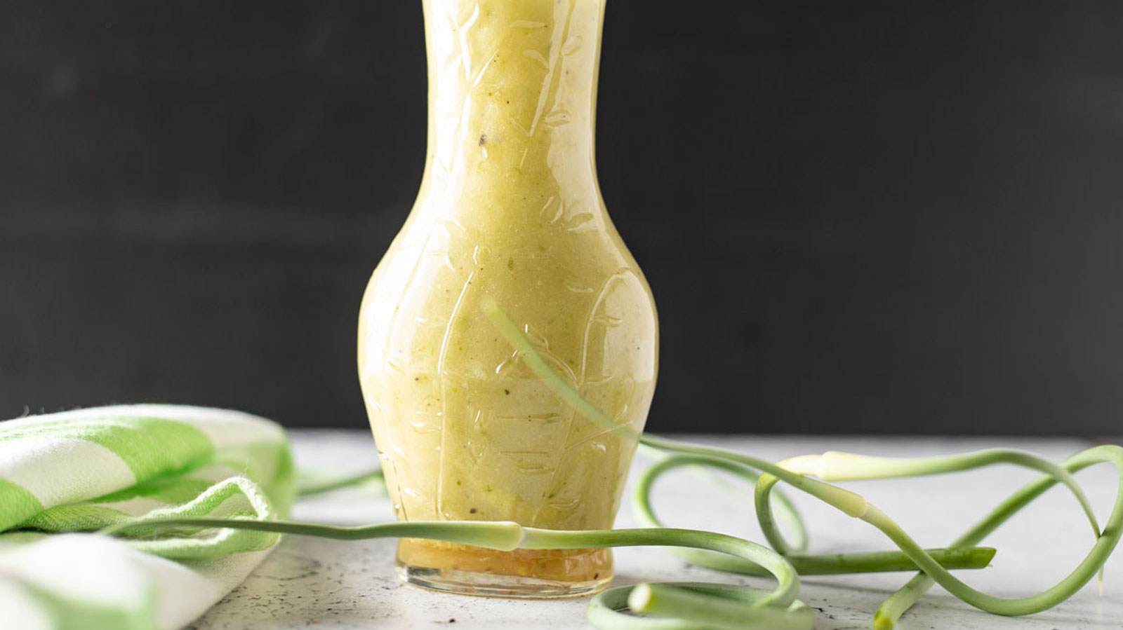 Garlic Scape Dressing in a cruet.